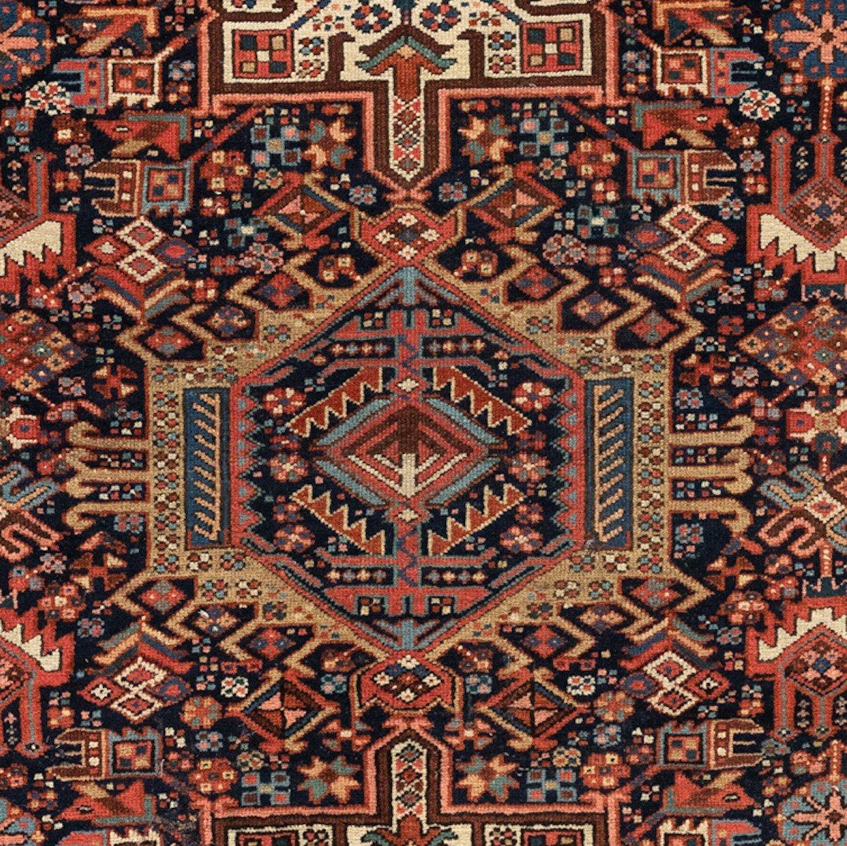 Antique Karaja (Black Mountain) rugs are woven in Iran near the Caucasian border and therefore exhibit Caucasian styles and motifs. This carpet measures 4.9 x 6.4 ft and is from 1940s.