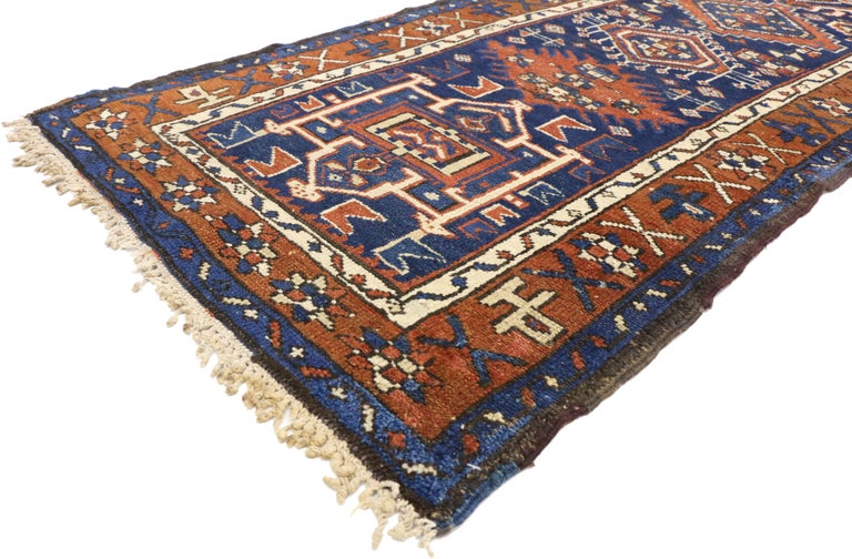 72591 Antique Persian Karaja Heriz Runner, Tribal Style Hallway Runner. This hand knotted wool antique Persian Karaja Heriz runner features a column of distinctive medallions and amulets similar to those found in Caucasian rugs. The central