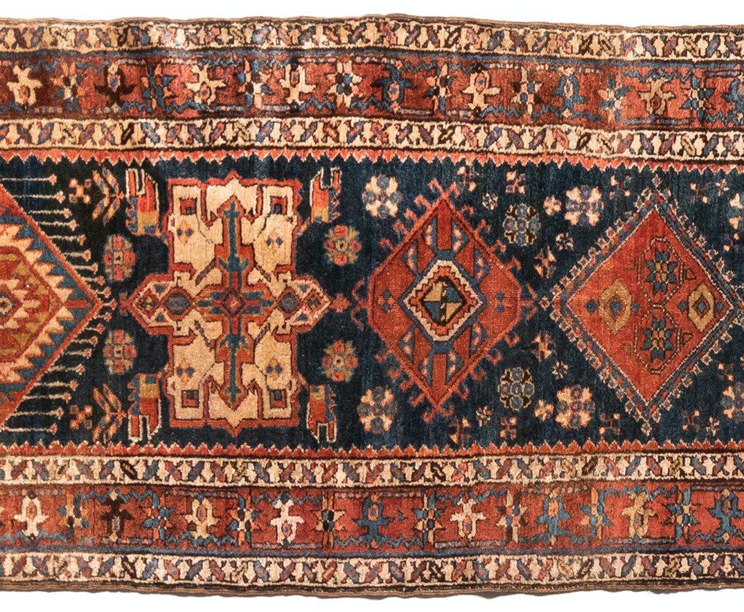 Antique Karaja (Black Mountain) rugs are woven in Iran near the Caucasian border and therefore exhibit Caucasian styles and motifs. This lovely runner measures 3 x 14.8 ft and is from 1920s.