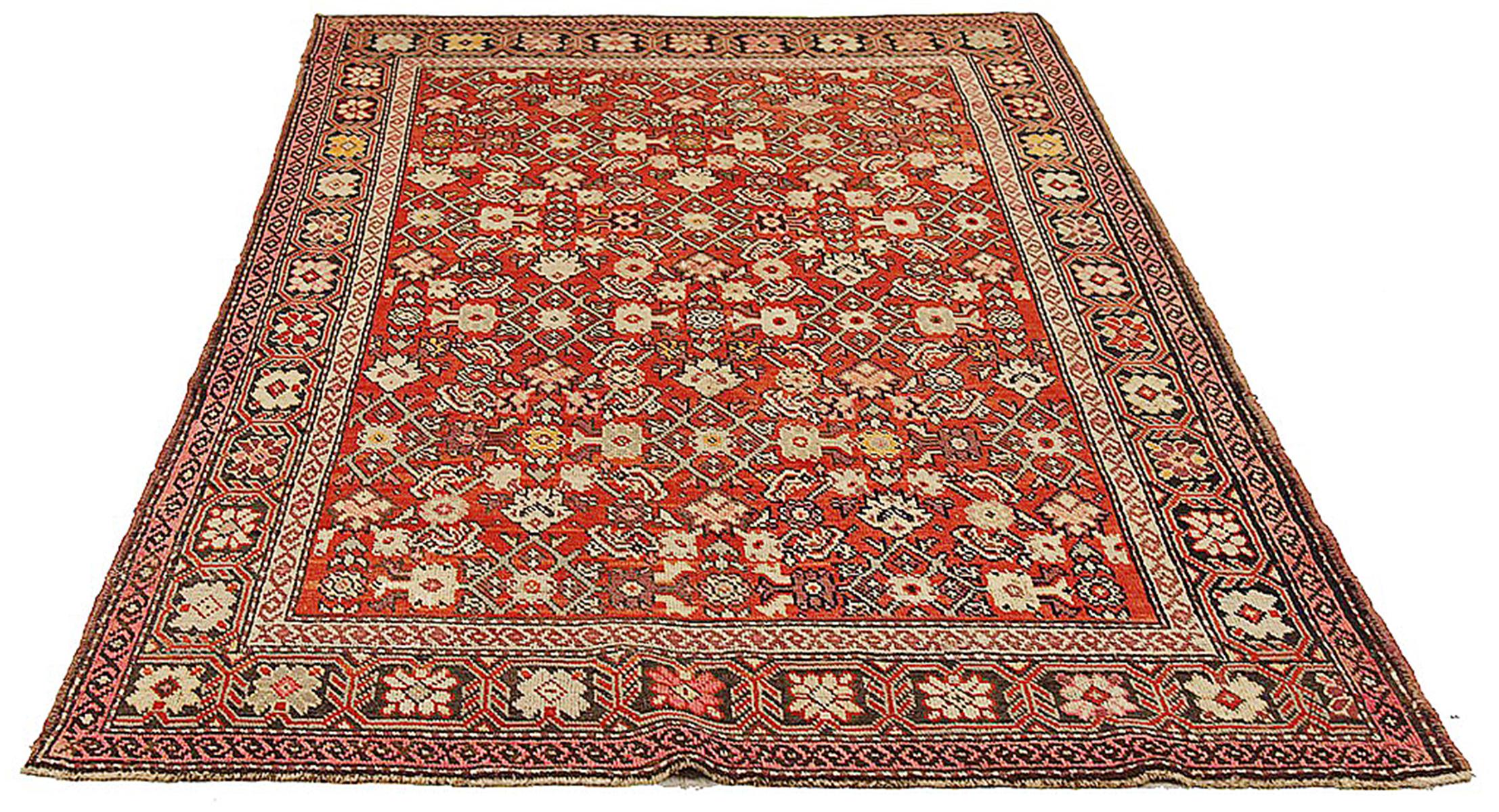 Antique Persian rug handwoven from the finest sheep’s wool and colored with all-natural vegetable dyes that are safe for humans and pets. It’s a traditional Karajeh design featuring floral medallions in ivory and black over a red center field. It’s