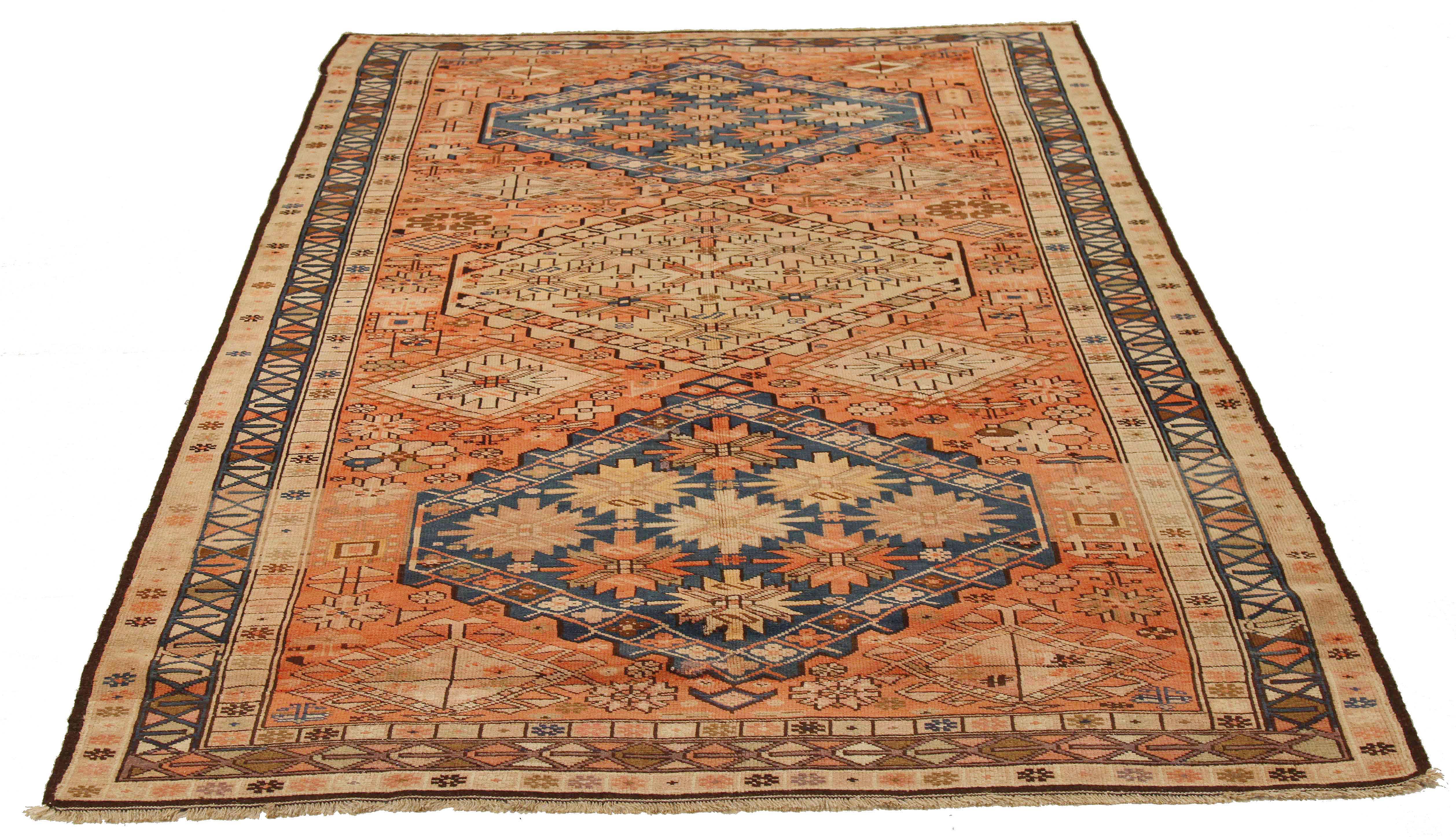 Antique Persian rug handwoven from the finest sheep’s wool and colored with all-natural vegetable dyes that are safe for humans and pets. It’s a traditional Karajeh design featuring floral medallions in navy and beige over a red-orange center field.