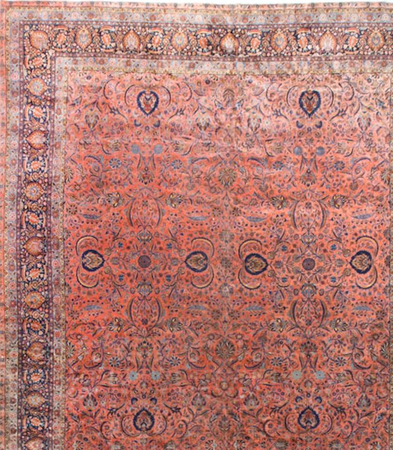 This is a large dramatic gallery size rug. With its soft main field and deep border it will sit so well in the correct setting. Situated on the caravan route to India in central Persia is the town of Kashan famed as one of the top quality production