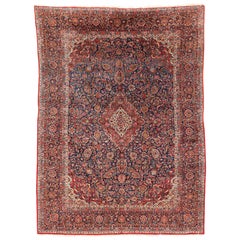 Antique Persian Kashan Hand-Knotted Wool Rug with Floral Design and Navy Field