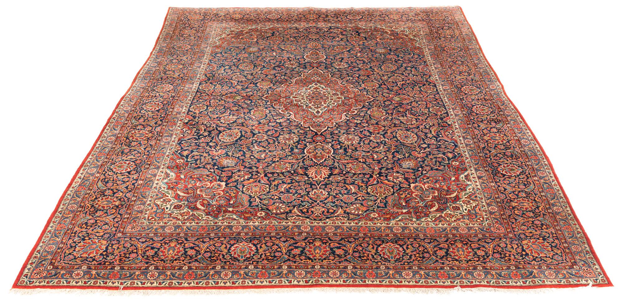 A wonderful example of the highest tier of quality carpets handwoven in Kashan, Persia in the early part of the 20th century.  The dominant feature of this piece is the highly elaborate and sophisticated floral design that fills the navy blue field