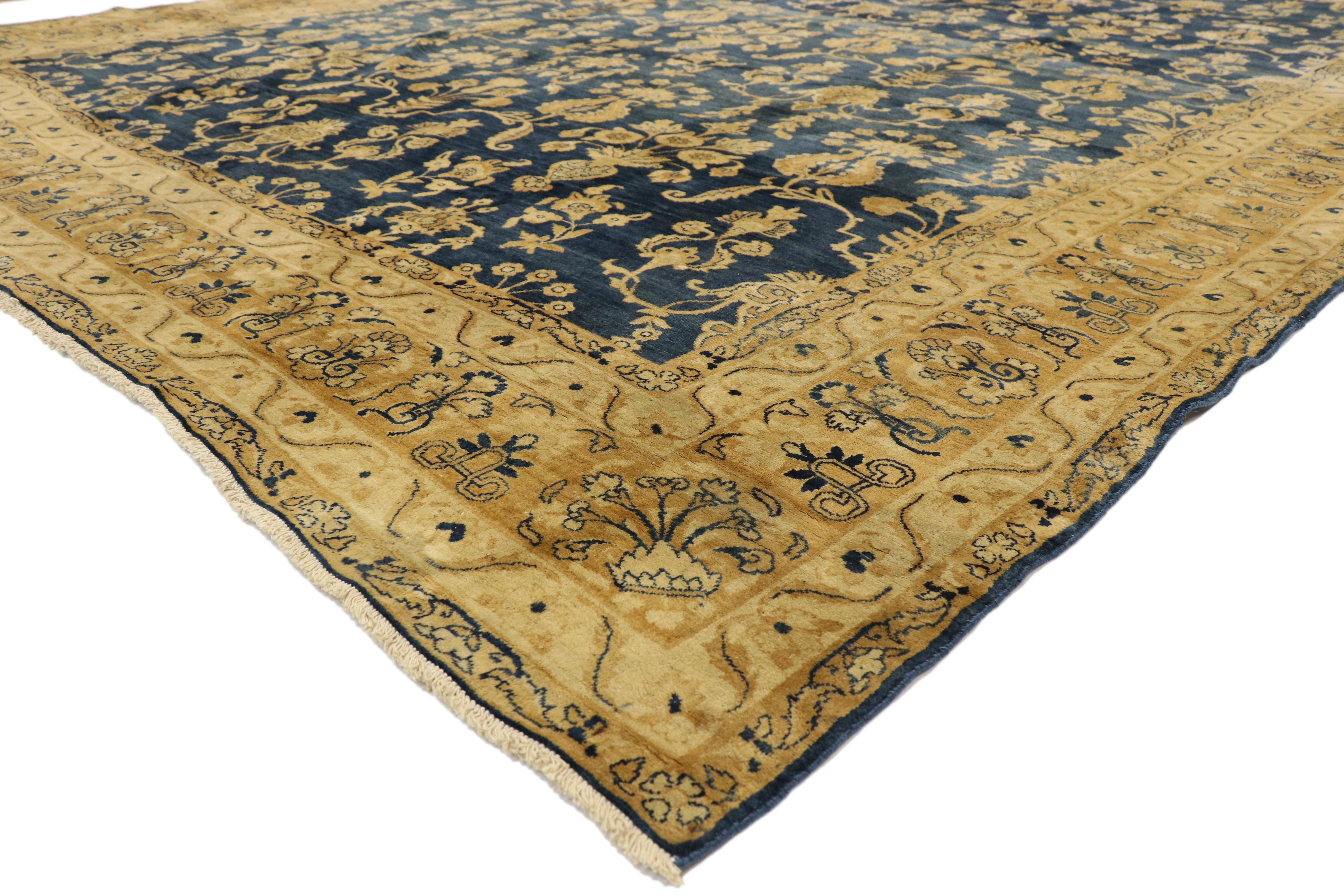 73375 Antique Persian Kerman Area Rug with Hollywood Regency Style. This gorgeous antique Kerman (Kirman) features a complex yet traditional design that spreads across the deep blue field of this lavish yet stately composition. From the allover