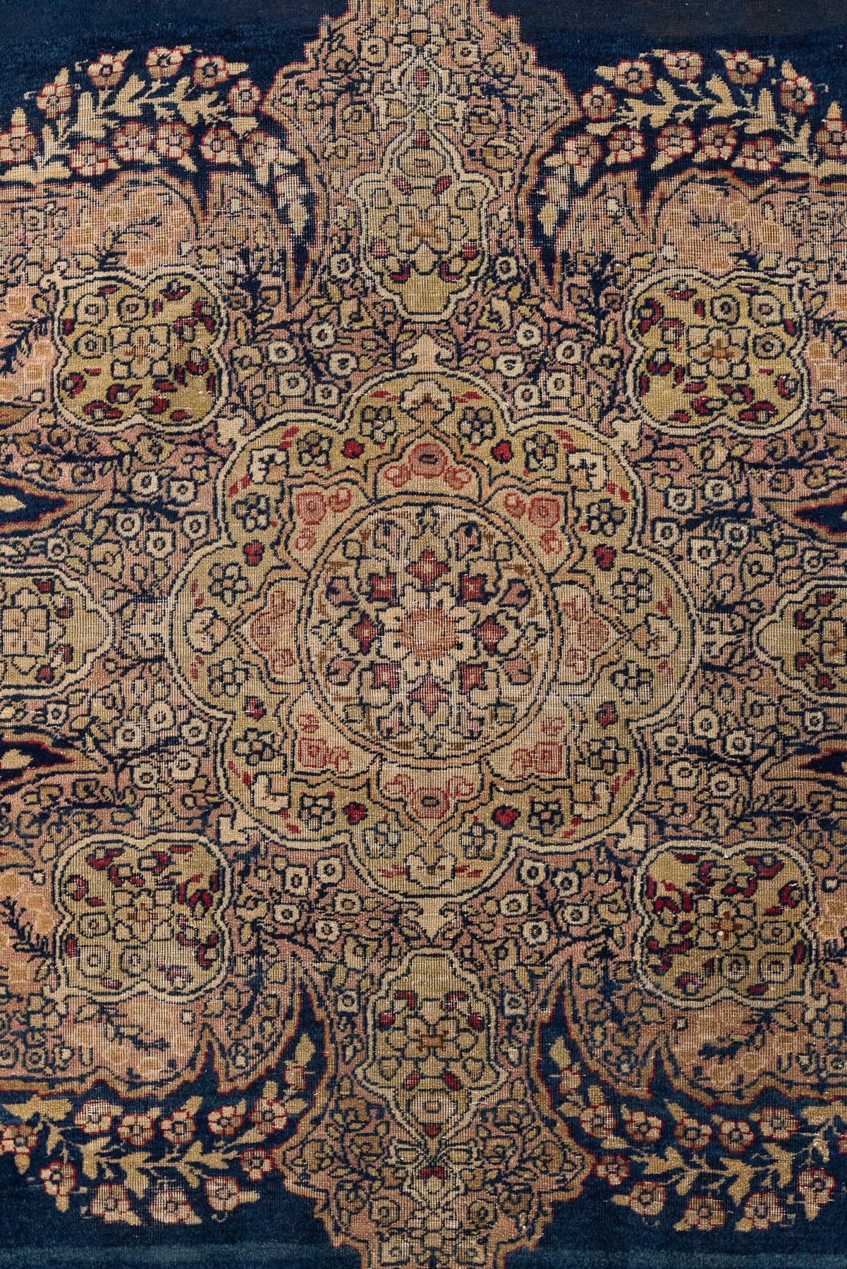 Kerman – South Persia

This luxurious medallion Kerman is made with flowers and vines in the centre of the navy-blue field of the rug. The highlight is the abrash technique used with different shades of blue, which provides depth and an admirable