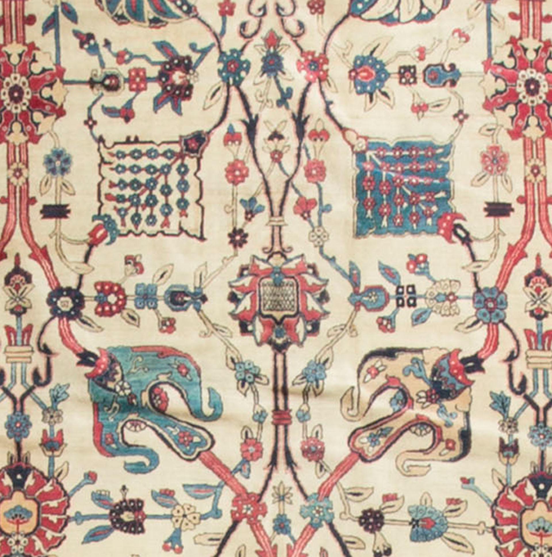 Antique Persian Kerman Lavar rug carpet, circa 1900, measures: 9'8 x 11'8. A lovely open ivory field with floral designs, entwined by a soft vine theme, weaving between the motifs. All enclosed within an ivory border and soft blue guard borders to