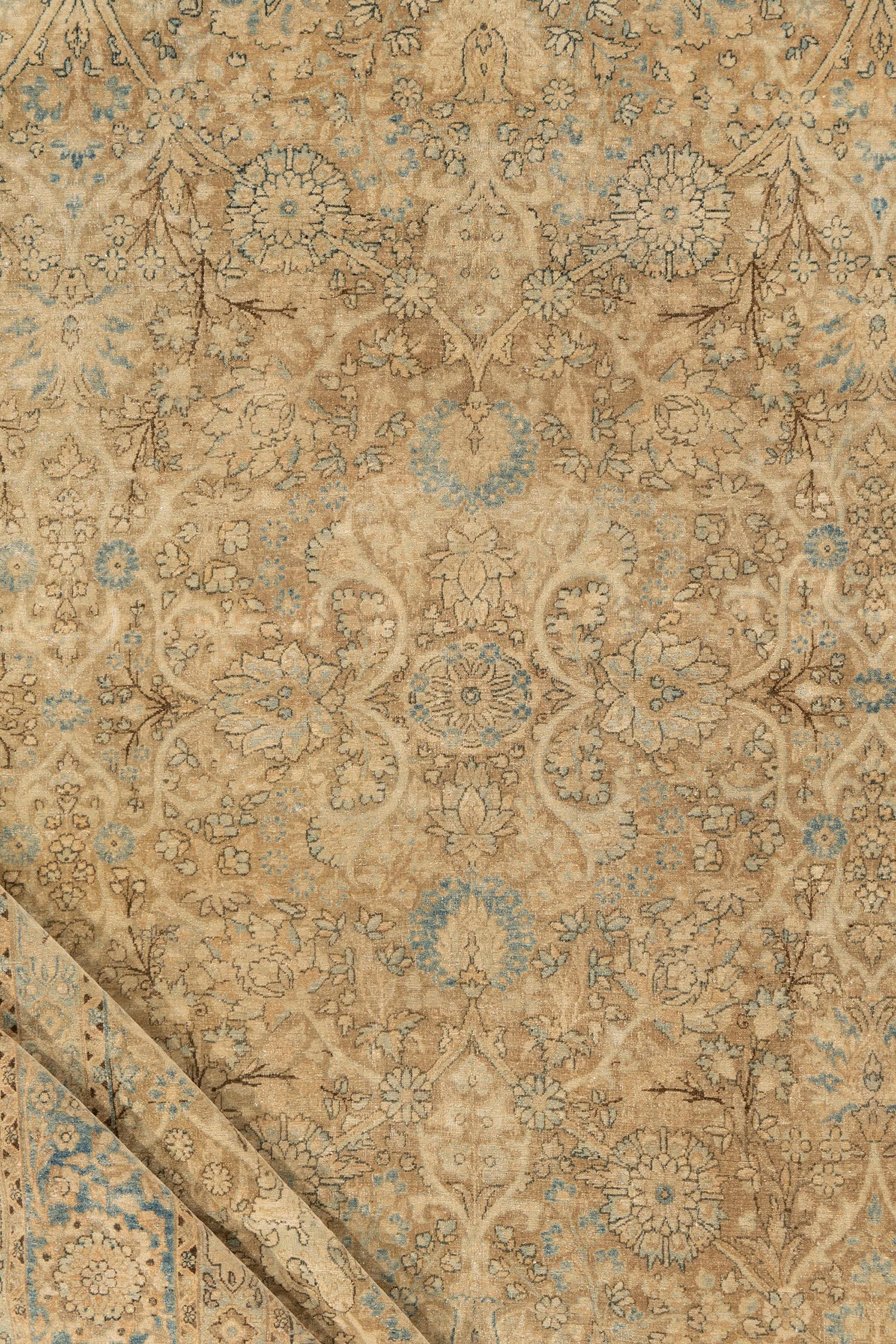 Antique Persian Kerman Rug 8'8 X 14'3. A soft and gentle design on an ivory field which blends in with the border to create this hand woven Kerman rug from Persia. Colors: Taupe/blue/beige/ivory/brown

