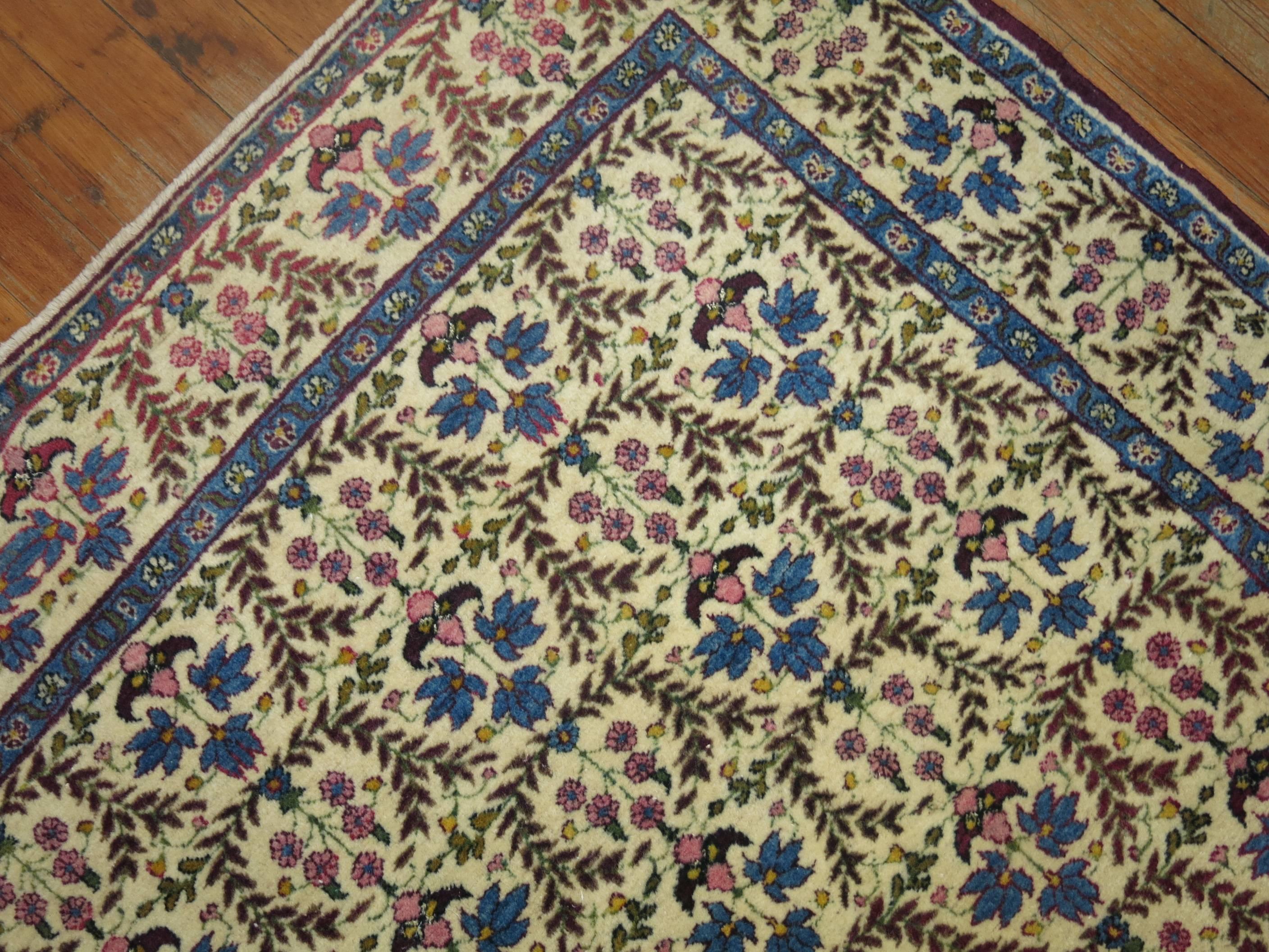 A 20th century Persian Kerman with a matching repetitive floral design in field and border.