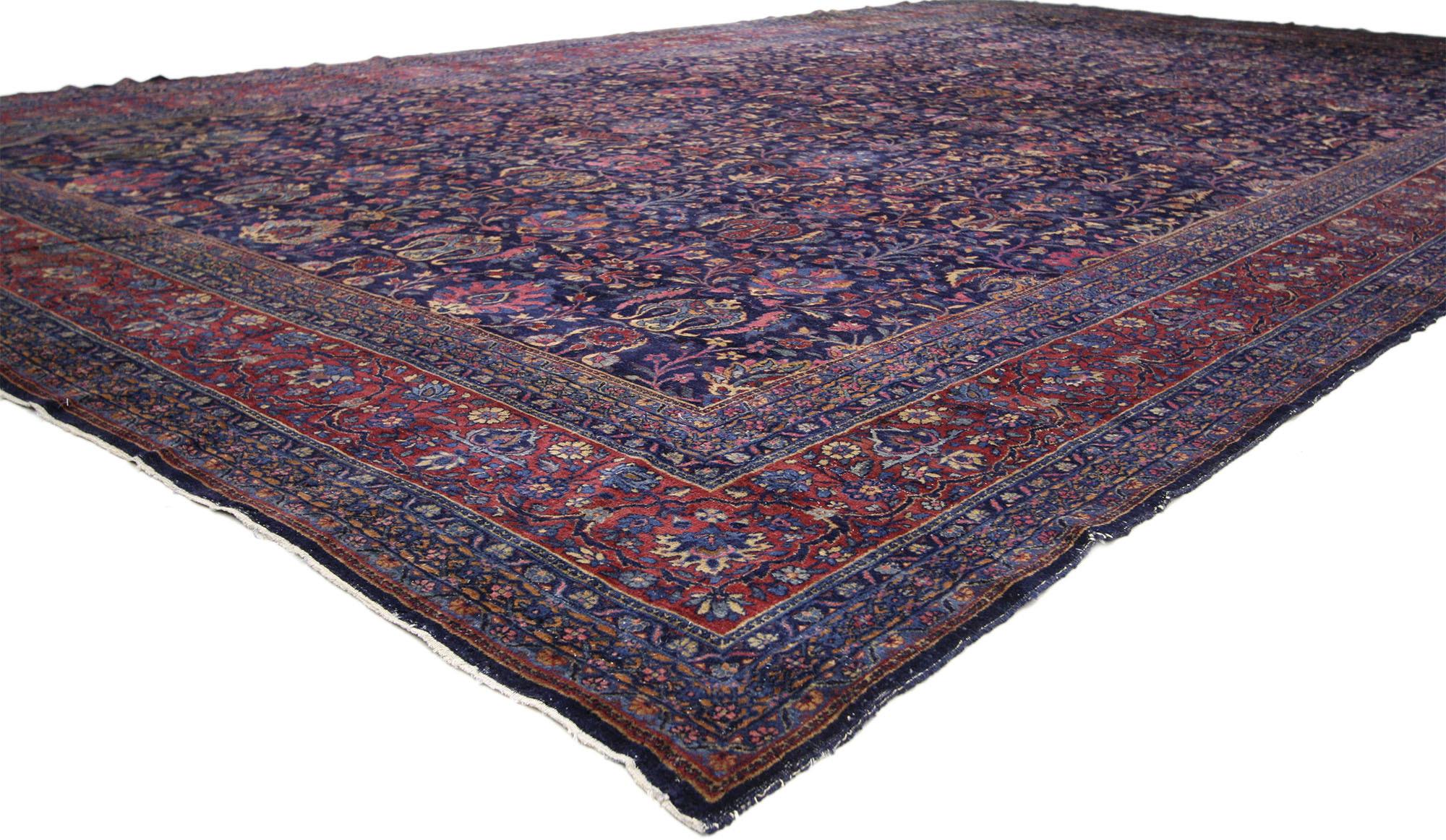 77185 Antique Persian Kerman Rug, 11’00 x 18’06. 
Captivating and irresistible with its dramatic backdrop and jewel-tone patterns this hand-knotted wool antique Persian Kerman rug is a theatrical experience with unexpected bursts of color and