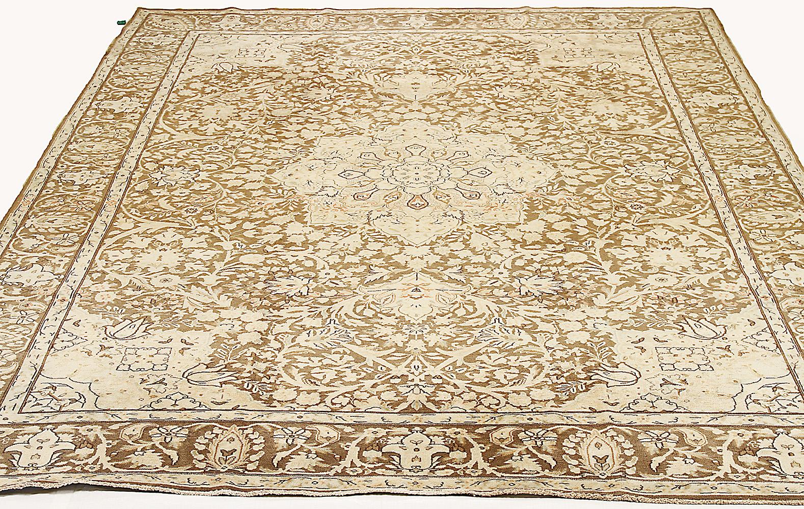 Antique Persian rug handwoven from the finest sheep’s wool and colored with all-natural vegetable dyes that are safe for humans and pets. It’s a traditional Kerman weaving featuring an elegant central medallion with an ensemble of floral designs in
