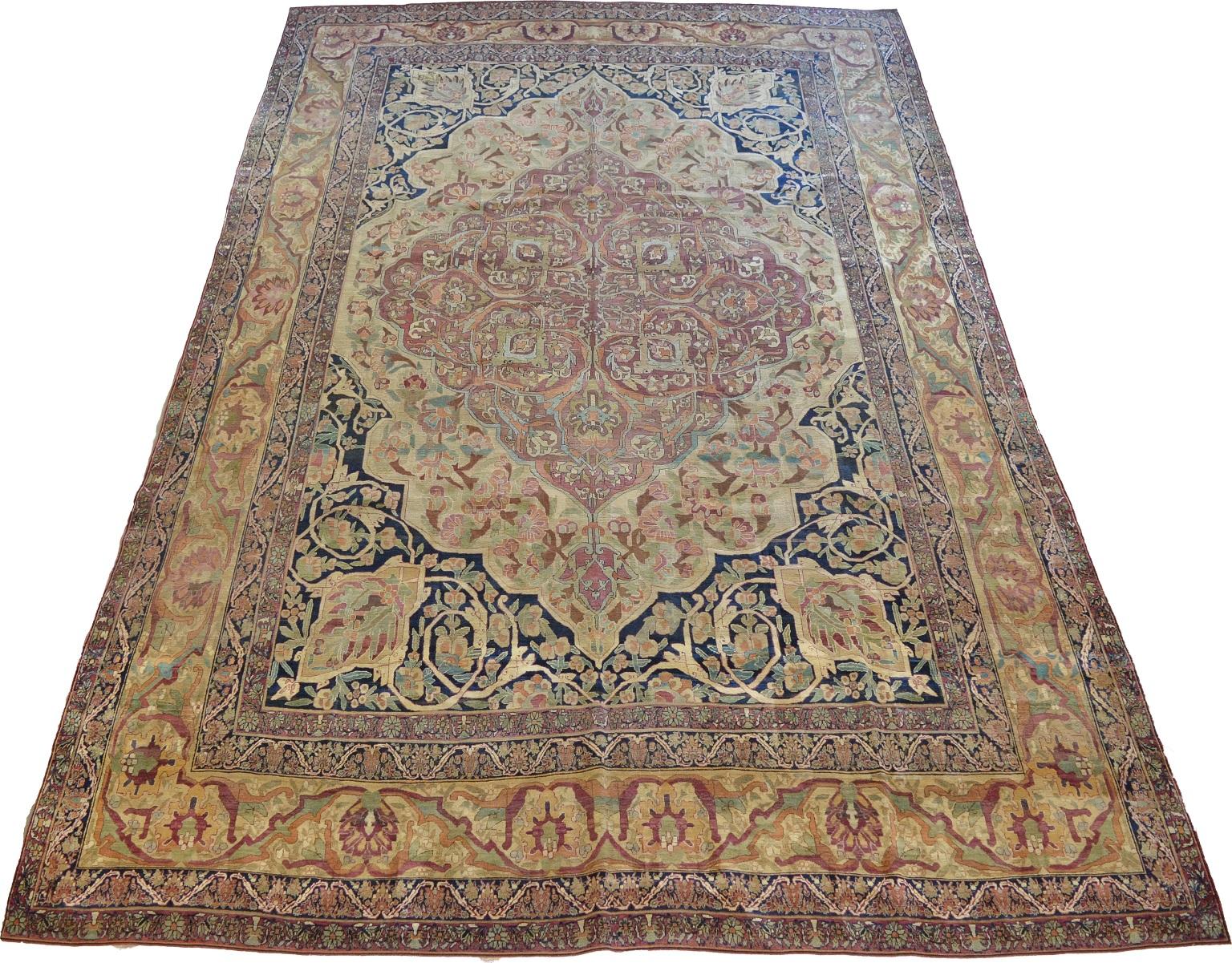 This antique Persian Kermanshah carpet created circa 1870 showcases a floral design with unique coloration and an elaborate central medallion. Created to honor Shah Naymatollah Ali, exceptional attention to detail has been given to every facet of