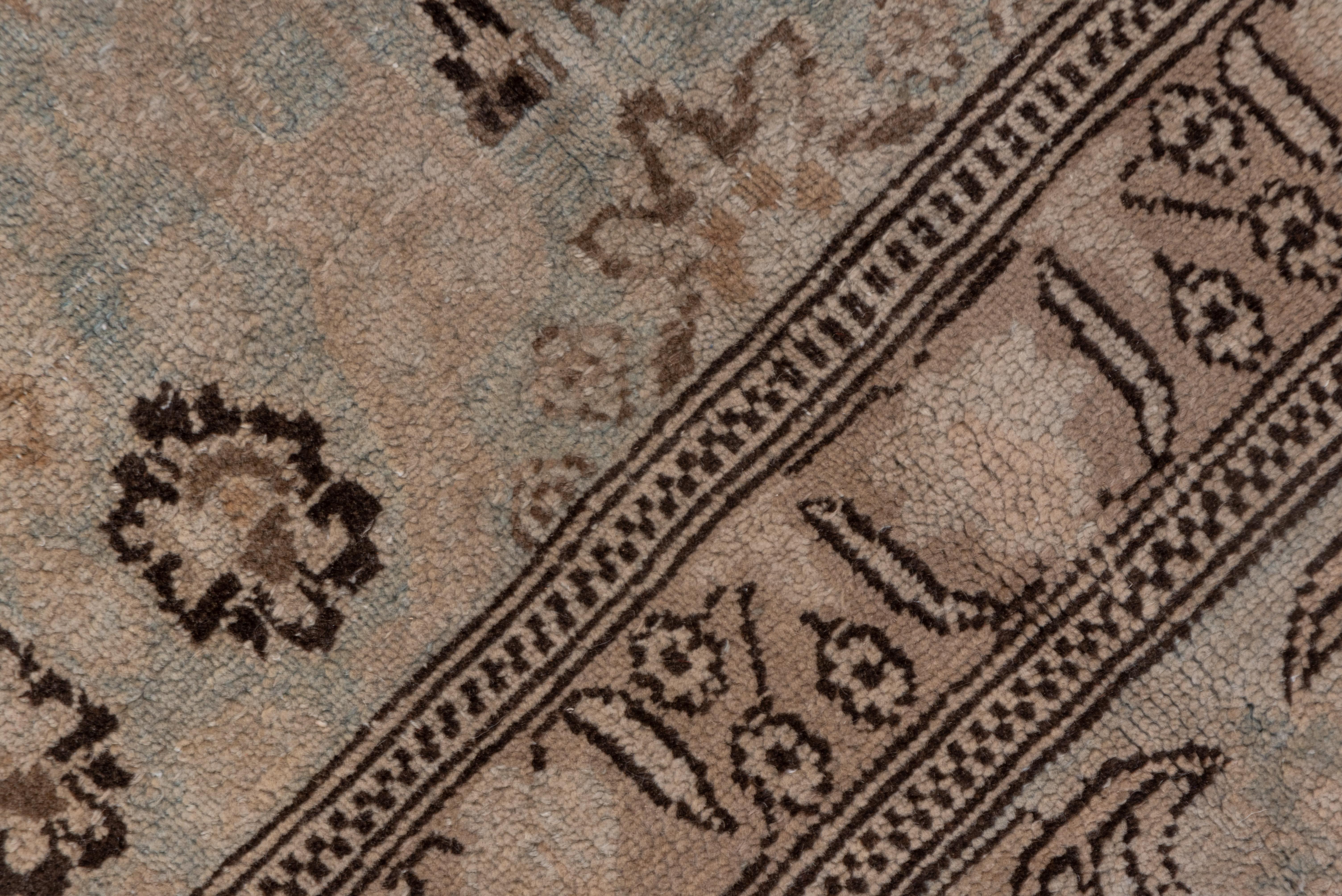 Dark umber floral details stand out against the light beige field with a modified all-over Herati design. Main border of long boteh-leaves and slanted profile palmettes. Tangerine flower pattern guards.