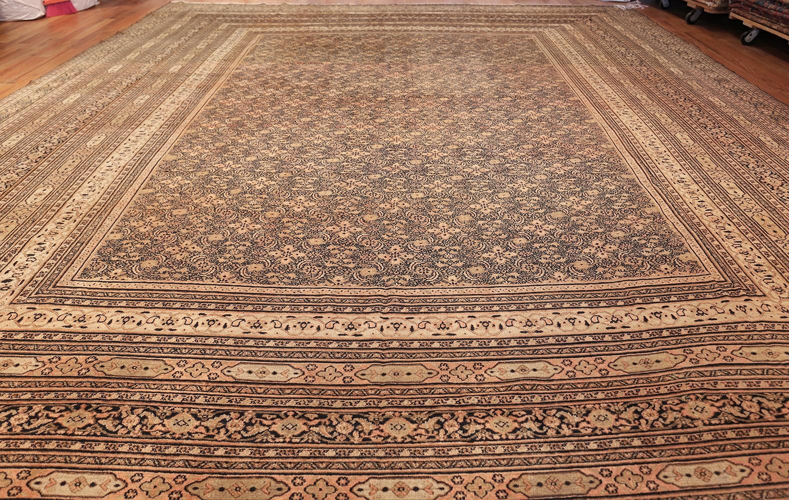 Antique Persian Khorassan carpet, country of origin: Persia, date circa 1920. Size: 15 ft 2 in x 18 ft (4.62 m x 5.49 m)

A simple color palette of neutrals is woven into an intricate piece of art, featuring detailed botanical motifs. As is