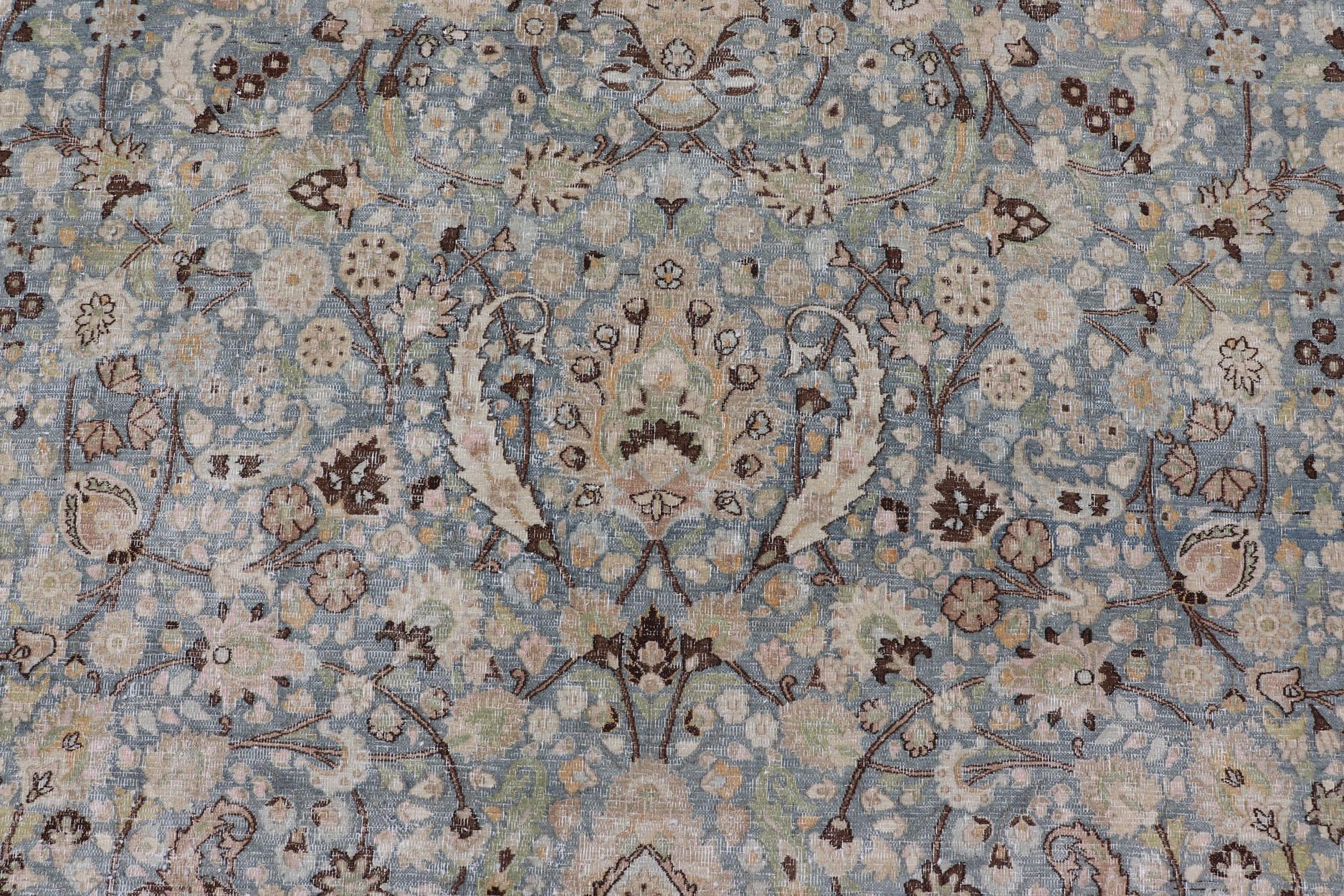 This spectacular antique Persian Khorasan carpet from early 20th century Iran bears a magnificent splendor indicative of royal tastes, which sought perfection in balance and palette. The all-over design displays various sweeping florals and