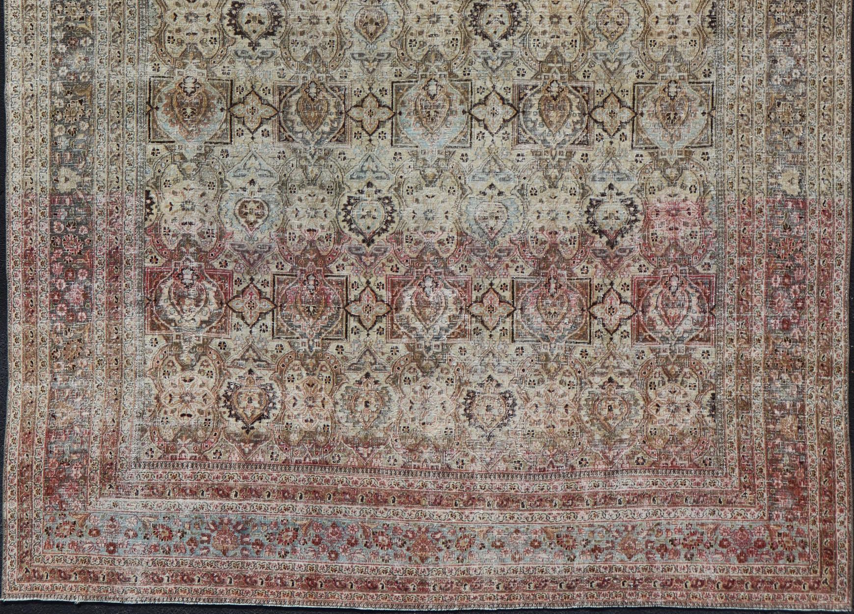 Distressed Antique Persian Khorassan Rug with Stretched Palmettes and Vining Flowers, Keivan Woven Arts rug/EMB-8503, origin/ Iran. Colors include light green background with accent colors of brown, salmon, soft blue, light orange and