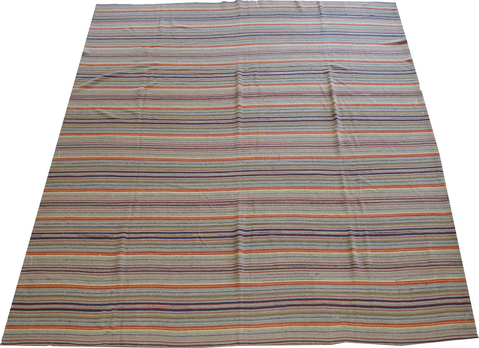 This antique Persian Kilim circa 1900 consists of handspun vegetal dyed and undyed wools. The colorful patterns of red, orange, yellow, blue and green amid a cream and gray background showcase the artist's creativity. The size is 9'7