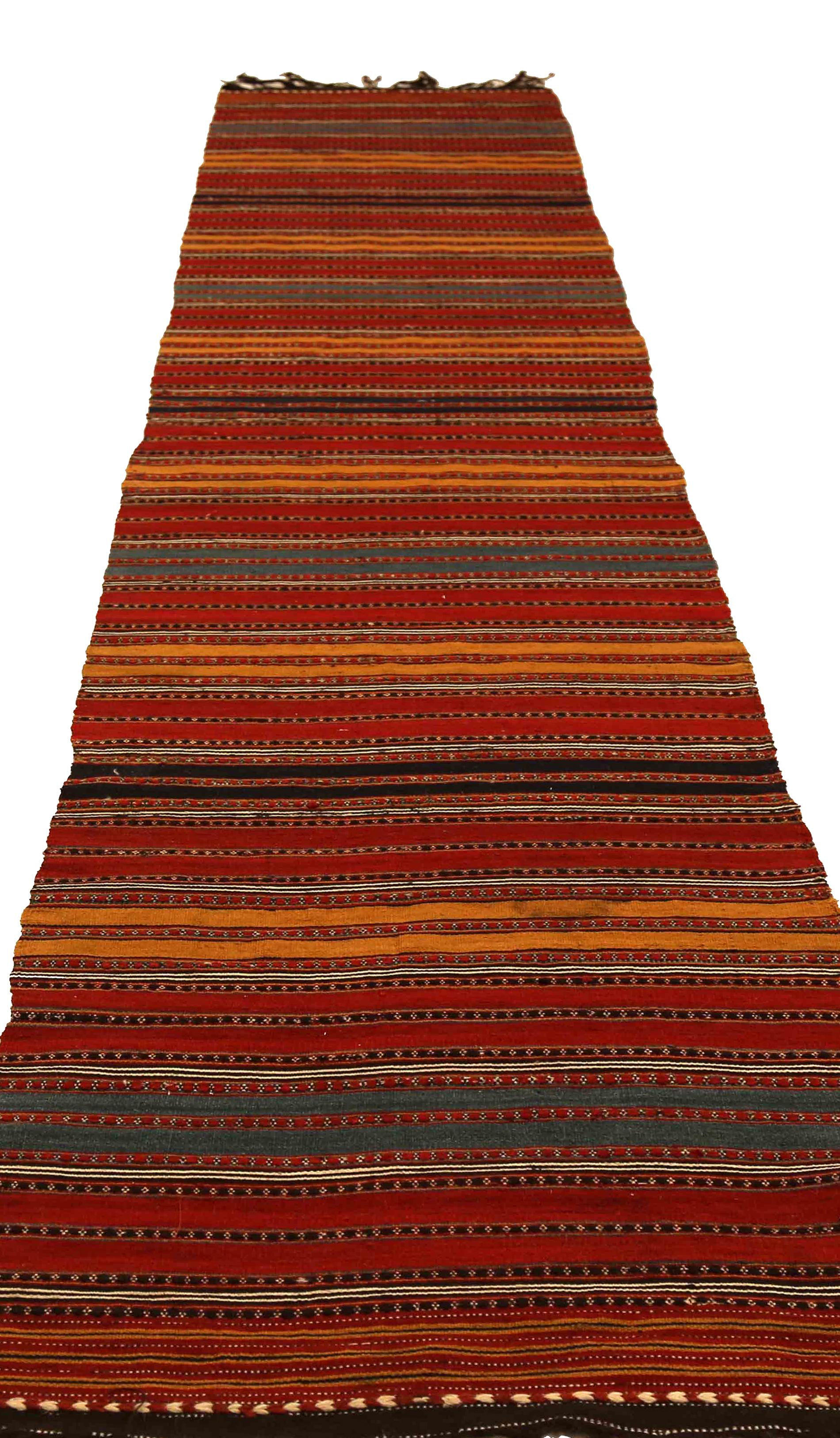 Antique handmade Persian runner rug from high quality sheep’s wool and colored with eco-friendly vegetable dyes that are proven safe for humans and pets alike. It’s a Classic Kilim design showcasing multicolored stripes. It’s a lovely piece that