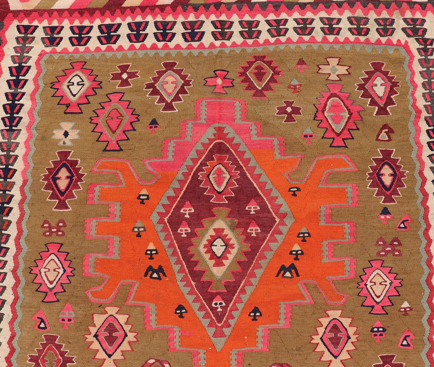 Measures: 5'3 x 11'0 

Antique Persian Kilim with Bold Geometric Medallions With Red and Orange 5'3 x11. Keivan Woven Arts/ rug/B25-0413-294, country of origin / type: Iran / Kilim, circa 1920.
An Antique Persian Kilim featuring a striking tribal