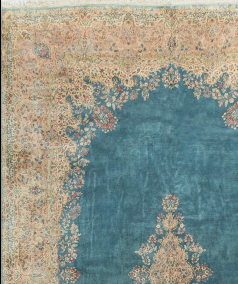 The light blue field coupled with the central medallion gives the feeling of an island surrounded by water in this delightful rug. The profusion of floral patterns in the large border only seem to add to the island feeling. Measures: 11'1