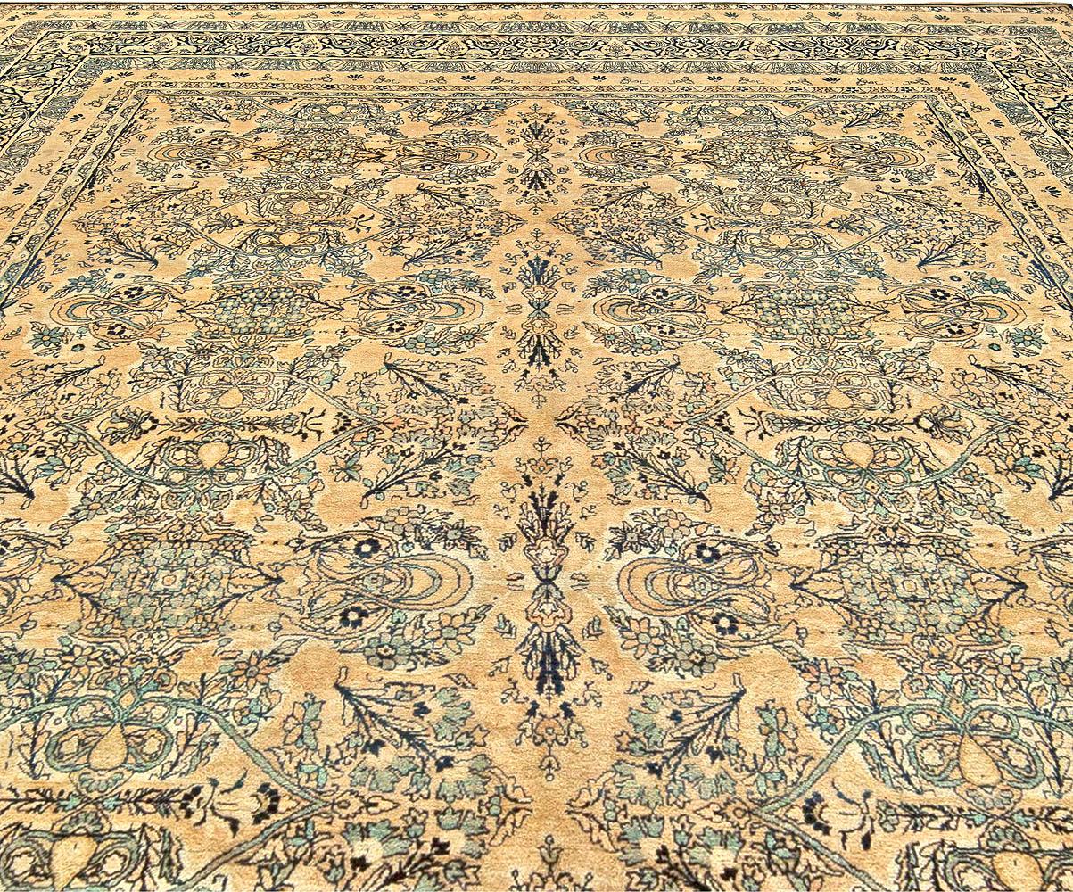 Antique Persian Kirman beige, inky blue, green and brown wool rug
Size: 9'10