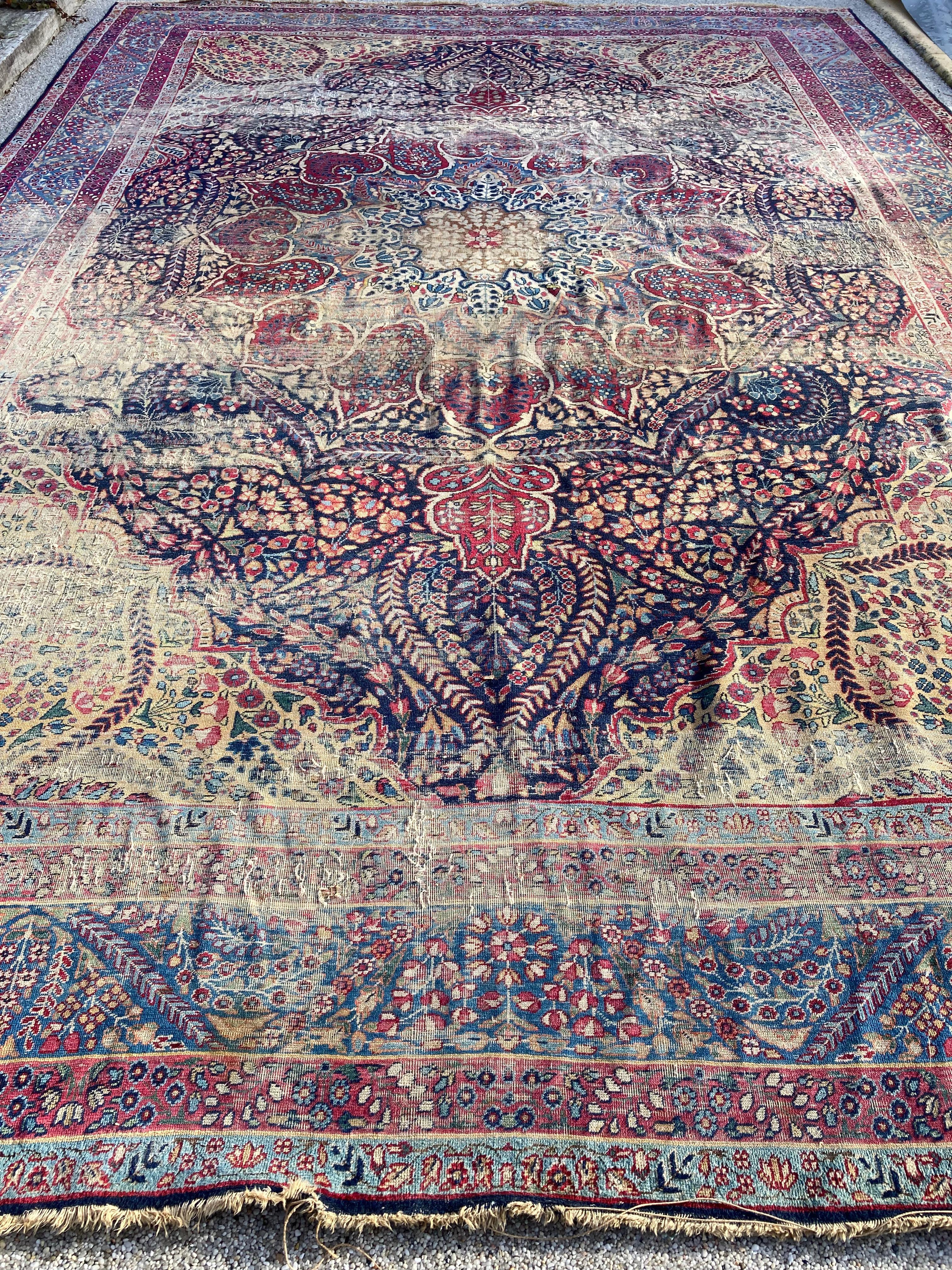 Antique Persian Kirman rug.

Antique Persian Kirman rug circa 1940. 
Worn but beautiful with an intricate floral pattern and unique colors.