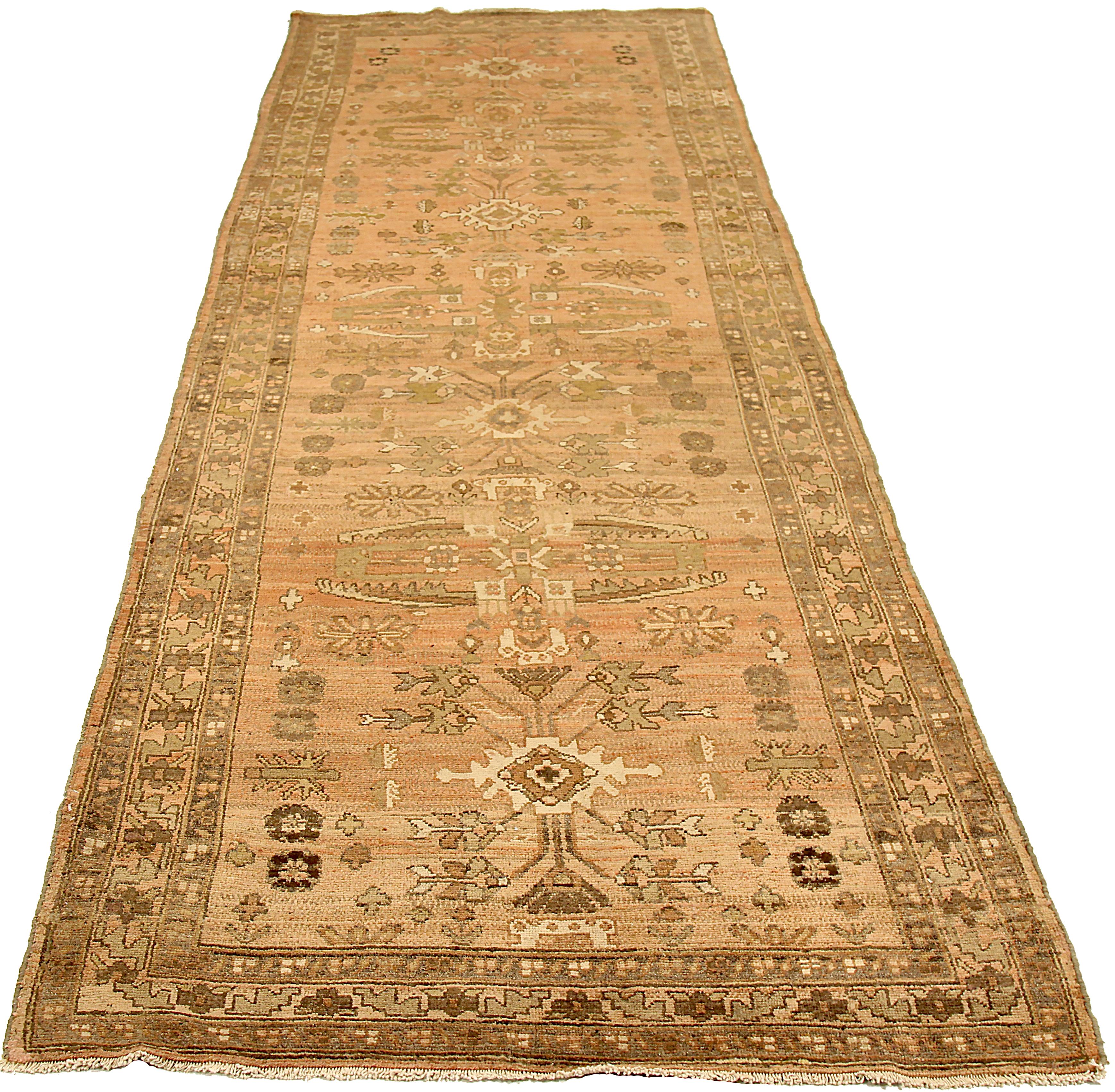 Antique Persian runner rug handwoven from the finest sheep’s wool and colored with all-natural vegetable dyes that are safe for humans and pets. It’s a traditional Koliai design featuring tribal and floral details on an ivory field. It’s a beautiful