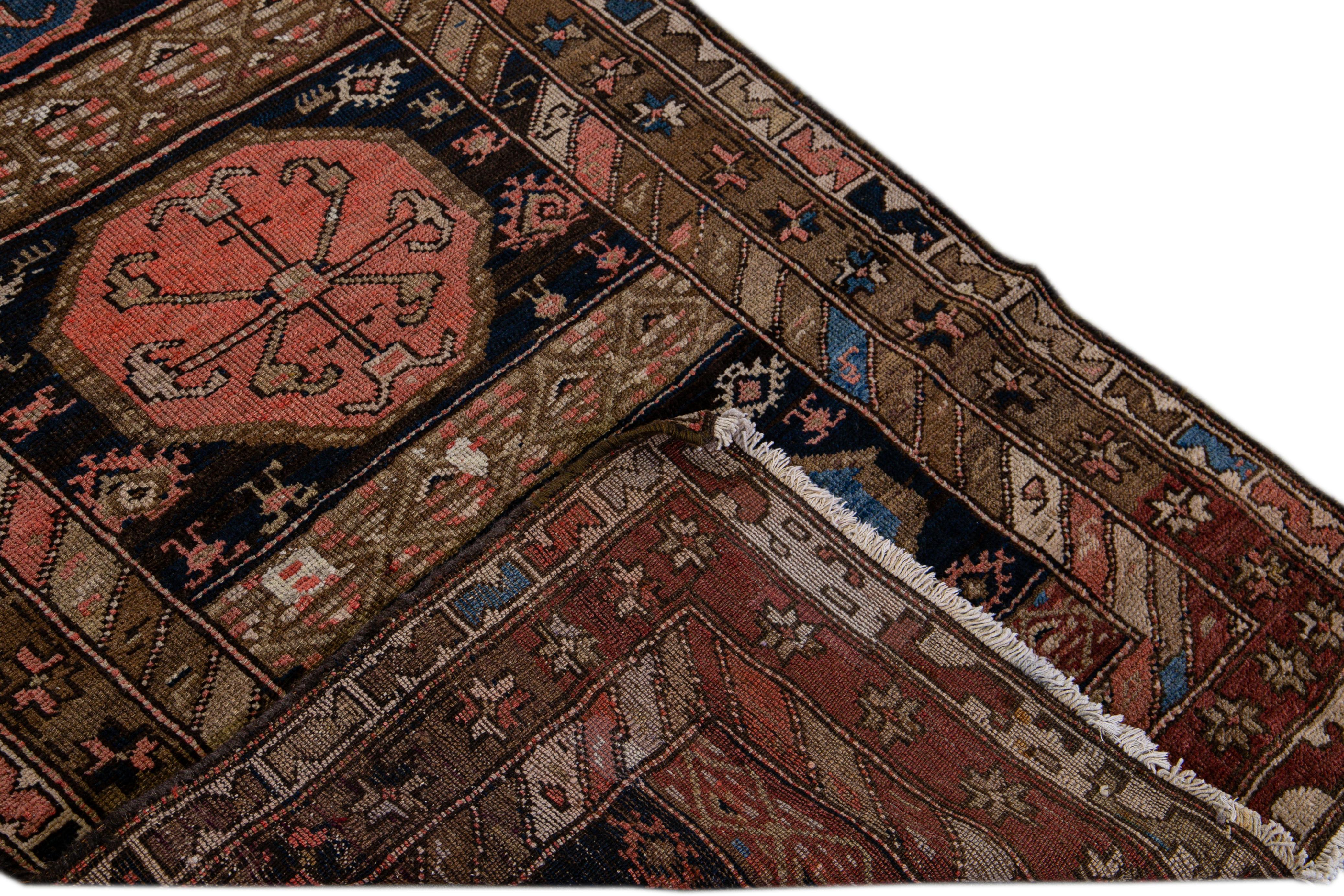 Beautiful antique Persian Kurd rug with a geometric medallion motif. This piece has fine details, great colors, and a beautiful design. It would be the perfect addition to your home. 

This rug measures 3'2 x 10'5