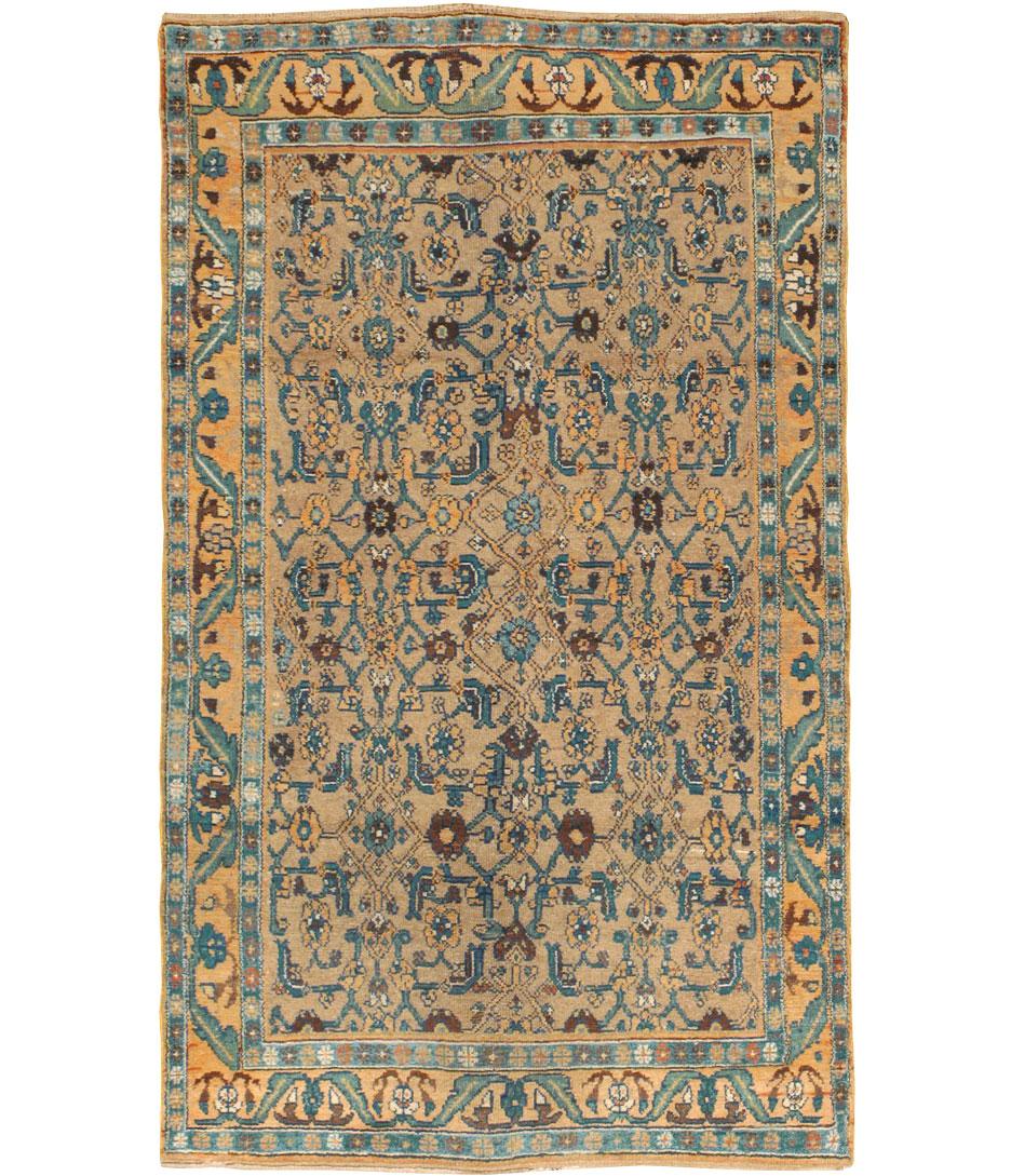 An antique tribal throw rug handmade by the Kurdish tribes of Persia during the early 20th century. An unusually large-scaled classic 