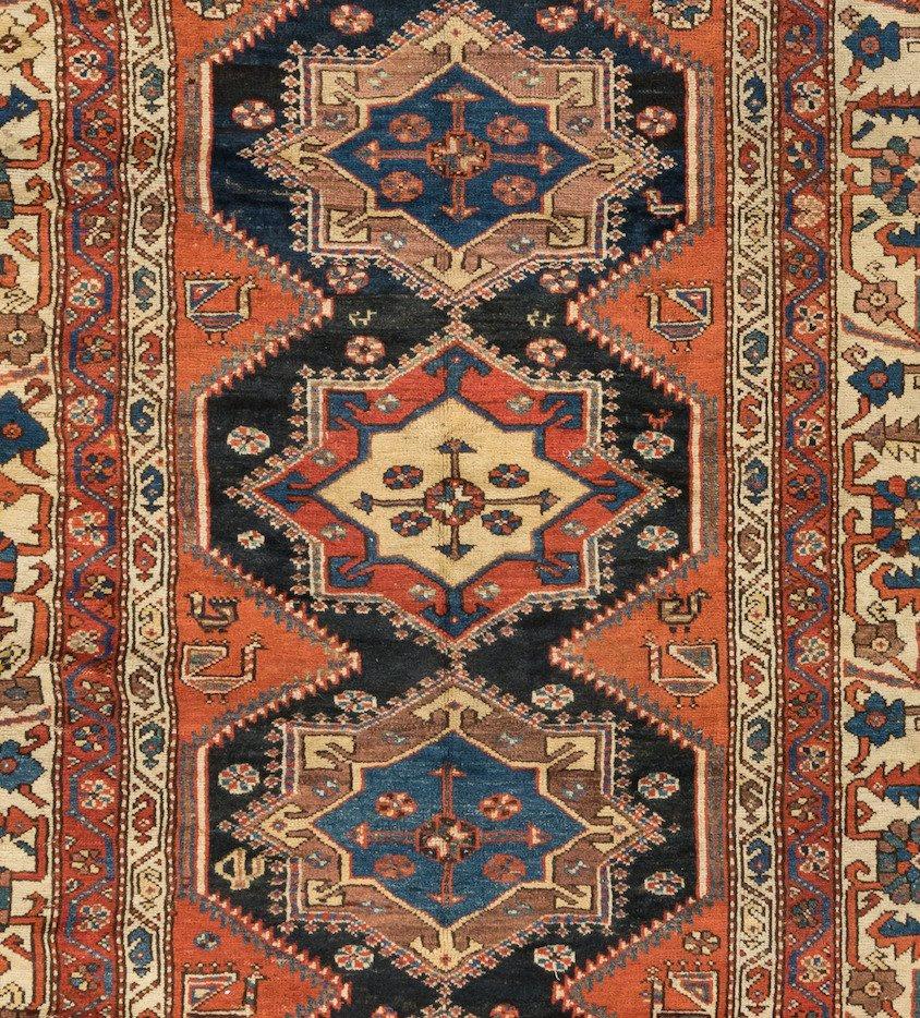 This lovely antique Persian Kurdish carpet measures 4.9 x 9 ft. and is from 1920s.