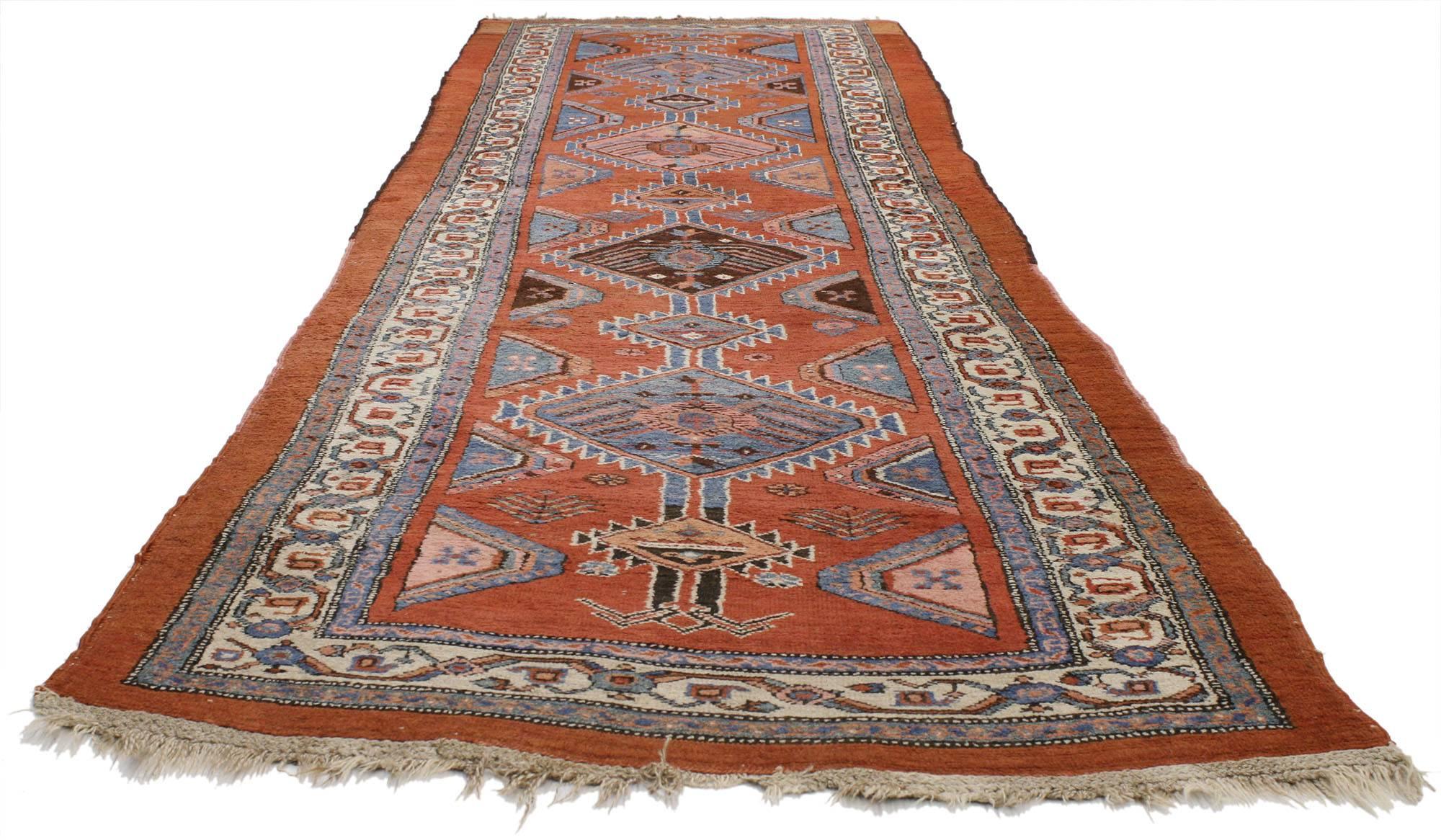 77054, Antique Persian Kurdish Hallway Runner with Tribal Style. Tribal with classic appeal, this antique Persian Kurdish runner features a row of beautiful baby blue, pink, and brown diamonds that anchor the field. Baby blue mounds ornament the