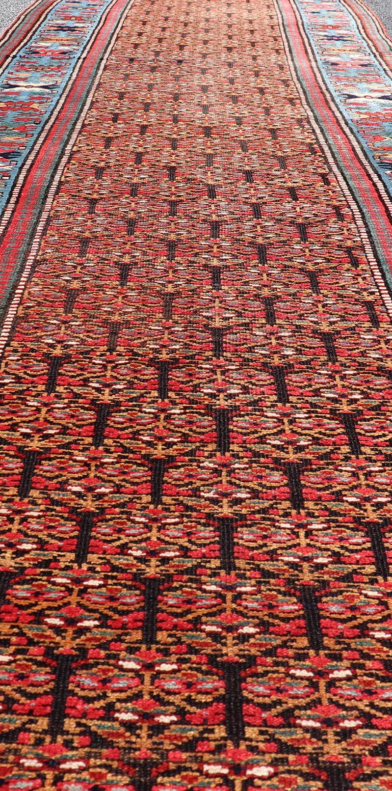 Hand-Knotted Antique Persian Kurdish Long Gallery Runner with Repeating Tribal Motif Design For Sale
