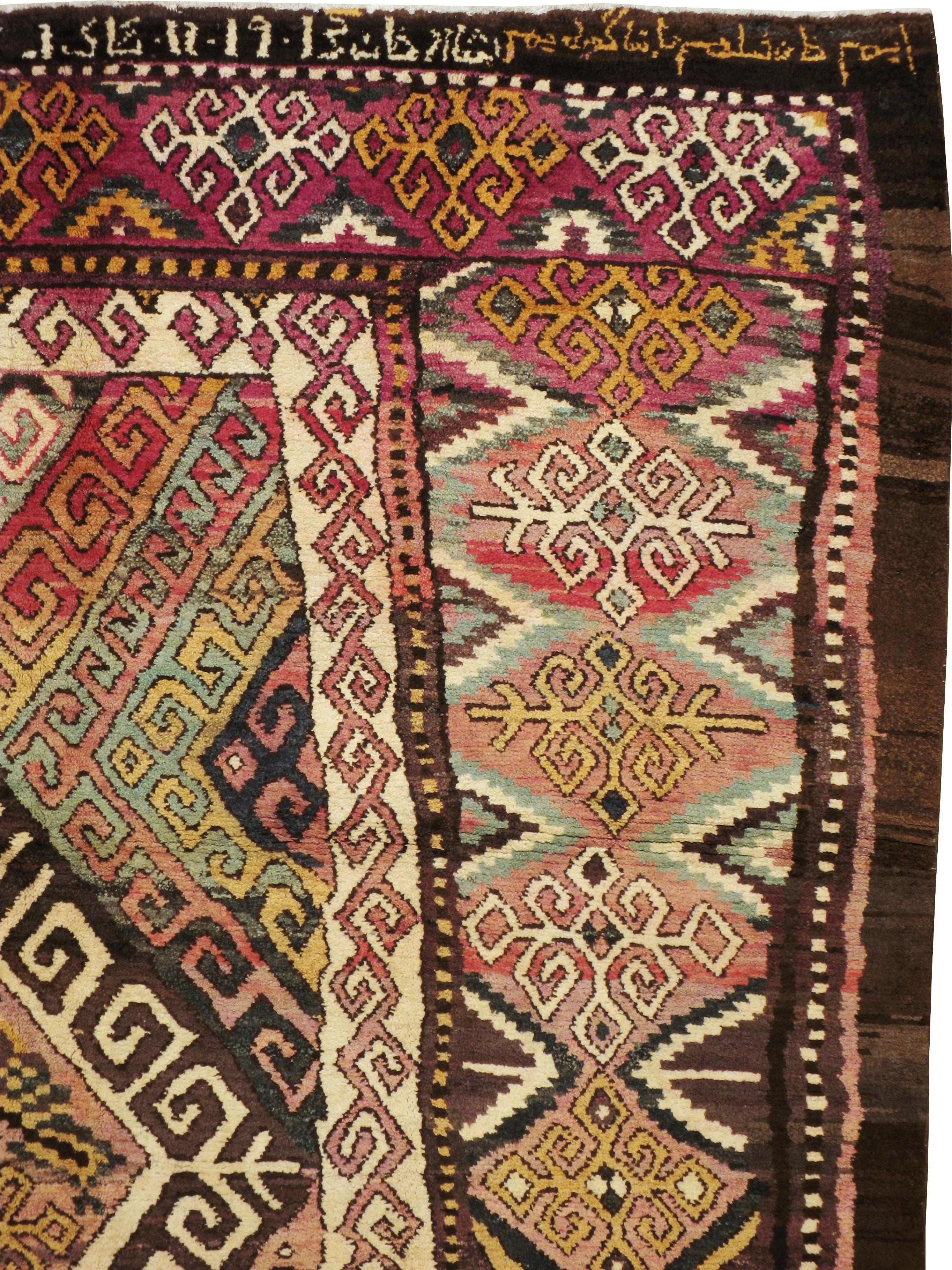 An antique Persian Kurdish accent rug from the early 20th century with an abstract multicolored pattern. The size, design, and colors are all very unique and rare characteristics for a nomadic and tribal origin and for this time period.