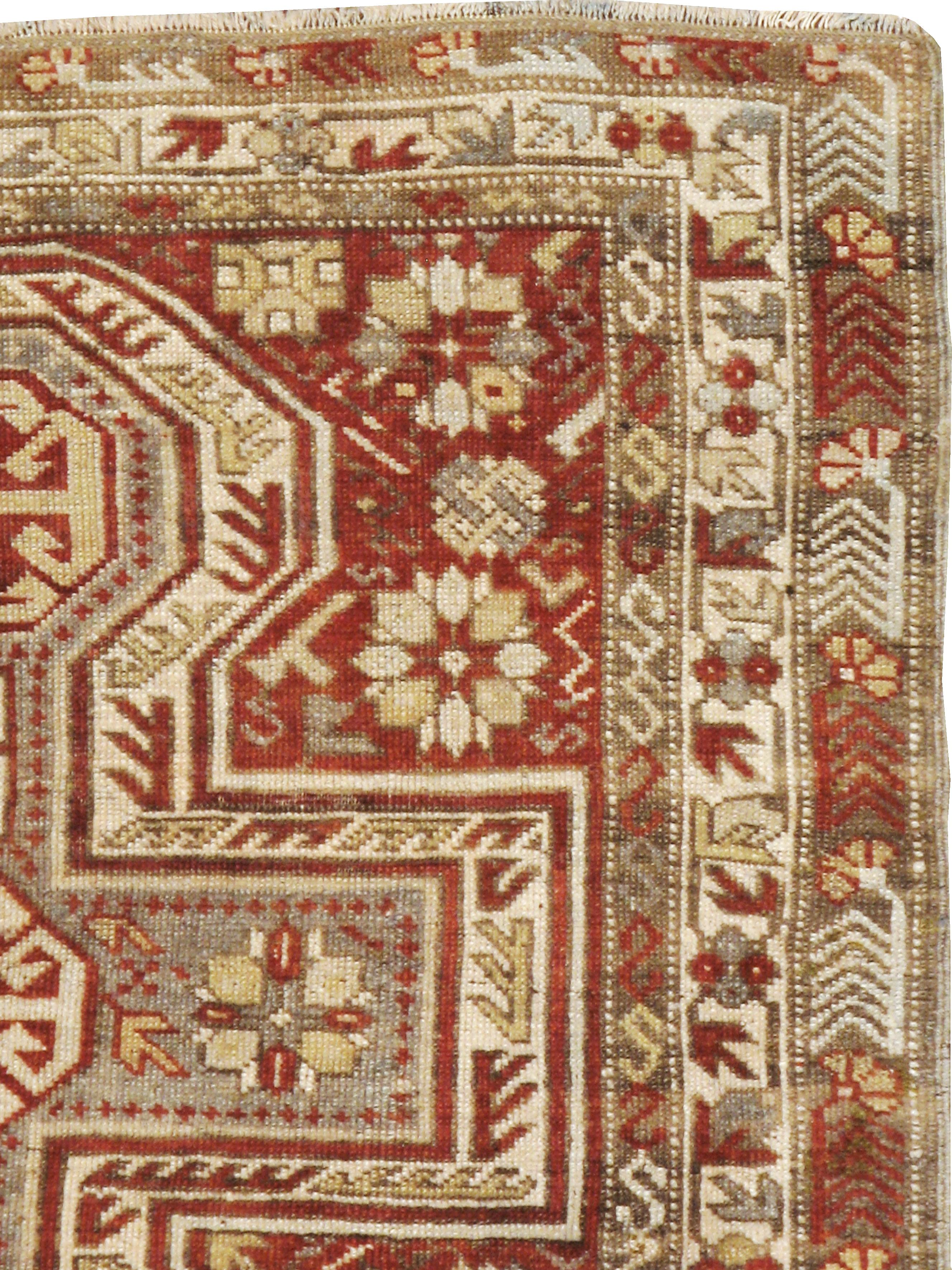 An antique Persian Kurd rug from the early 20th century.