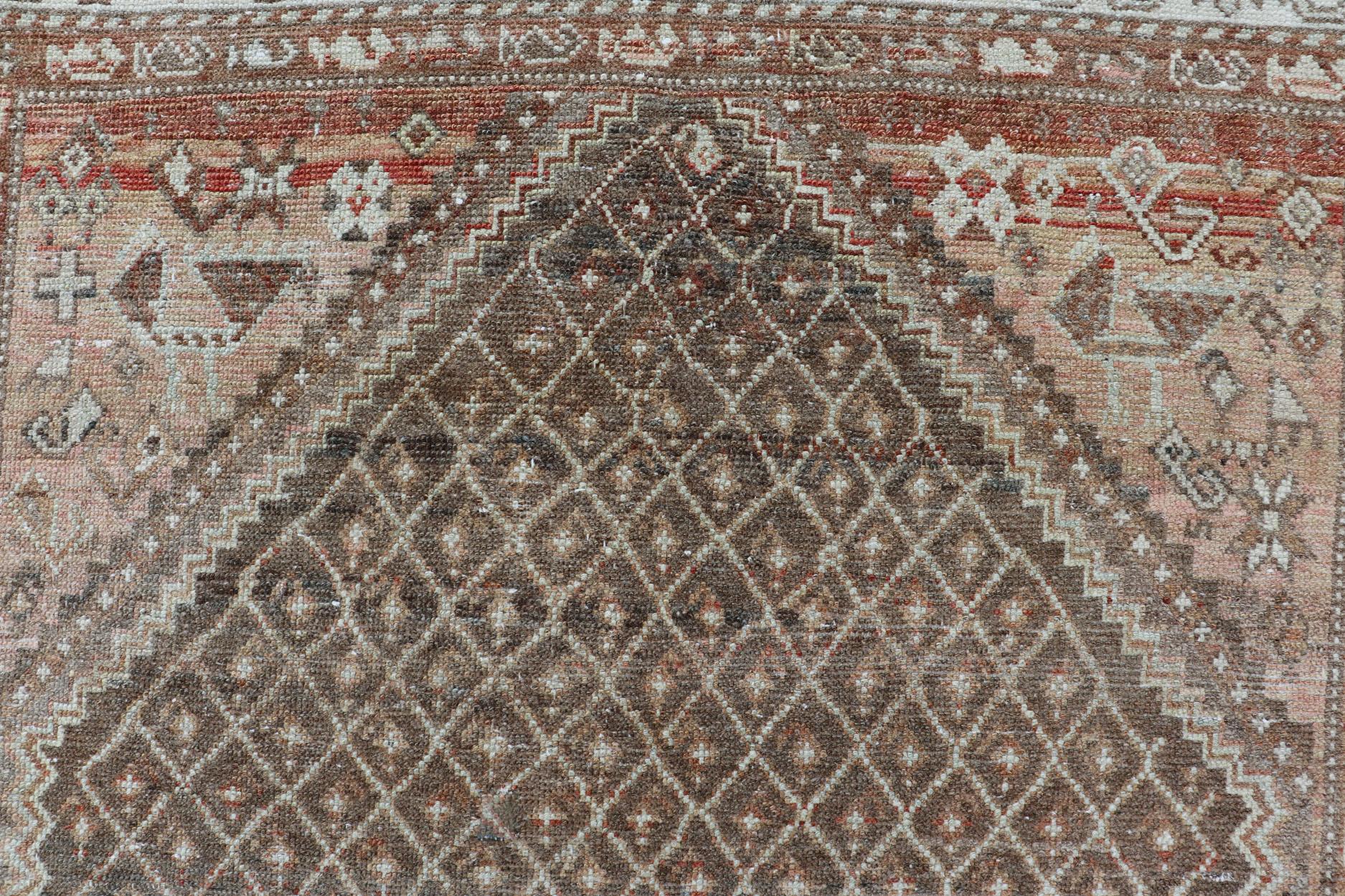 Softly colored antique distressed Persian Kurdish with all-over tribal design in soft colors of gray, charcoal, brown, tan cream, green , rug EMB-8529-178682, country of origin / type: Iran / Kurdish, circa 1910.

This antique distressed Kurdish