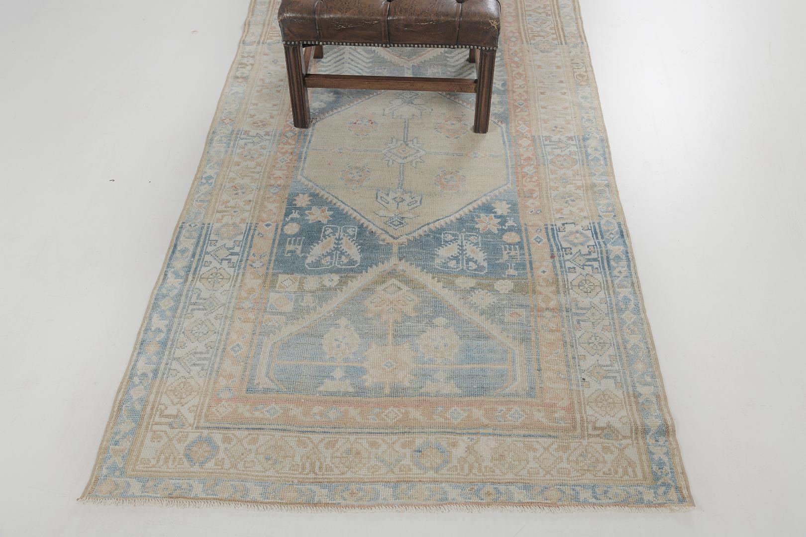 This phenomenal Antique Persian Kurdish is in cream, aegean blue, cinnamon and ivory blend of colours. It is distinguished by its stunning series of medallions lining up together to create a mesmerizing piece that will surely captivate the viewer’s