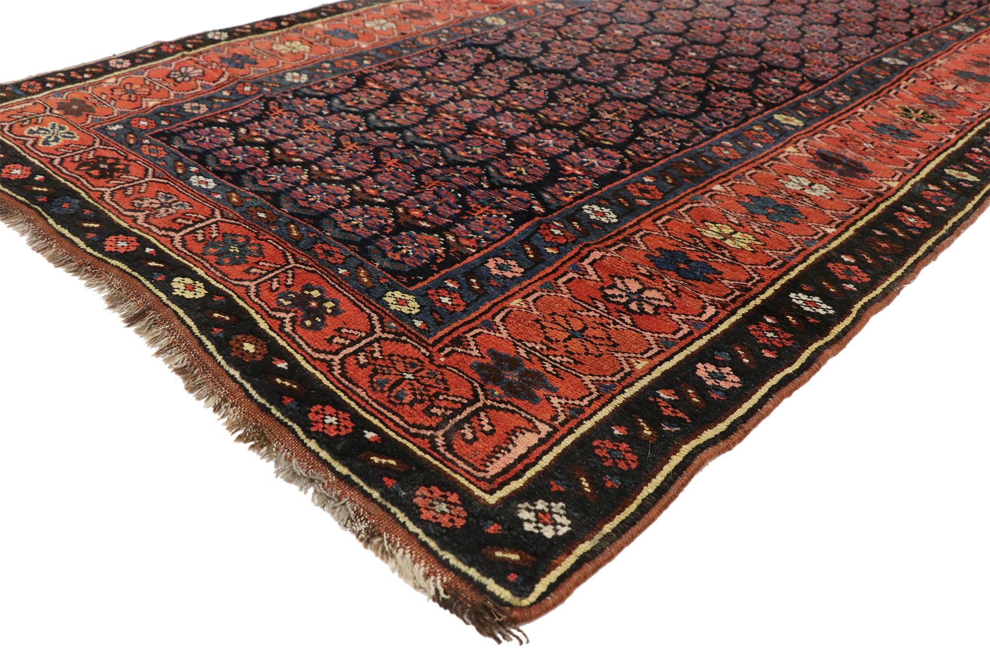 76603, antique Persian Kurdish runner with Boteh design, hallway runner. This hand-knotted wool antique Persian Kurdish runner features an all-over geometric repetition of the Boteh design on an ink blue background. The Boteh resembles sprouting