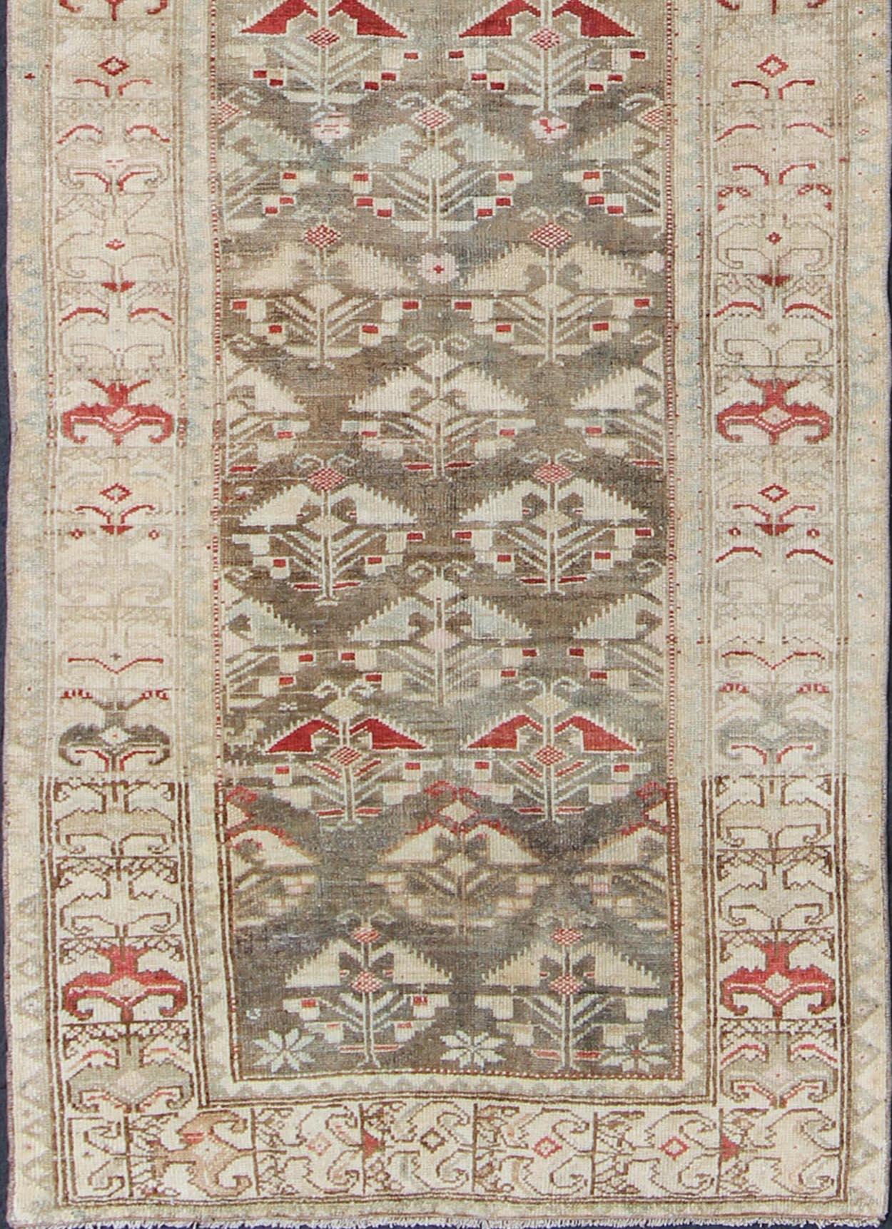 Gray green, charcoal, red, gray, runner from Persia vintage Kurdish with all-over repeating geometric design and neutral colors, kwarugs / ema-7518, country of origin / type: Iran / Kurdish, circa 1930.

This vintage Kurdish tribal rug was woven