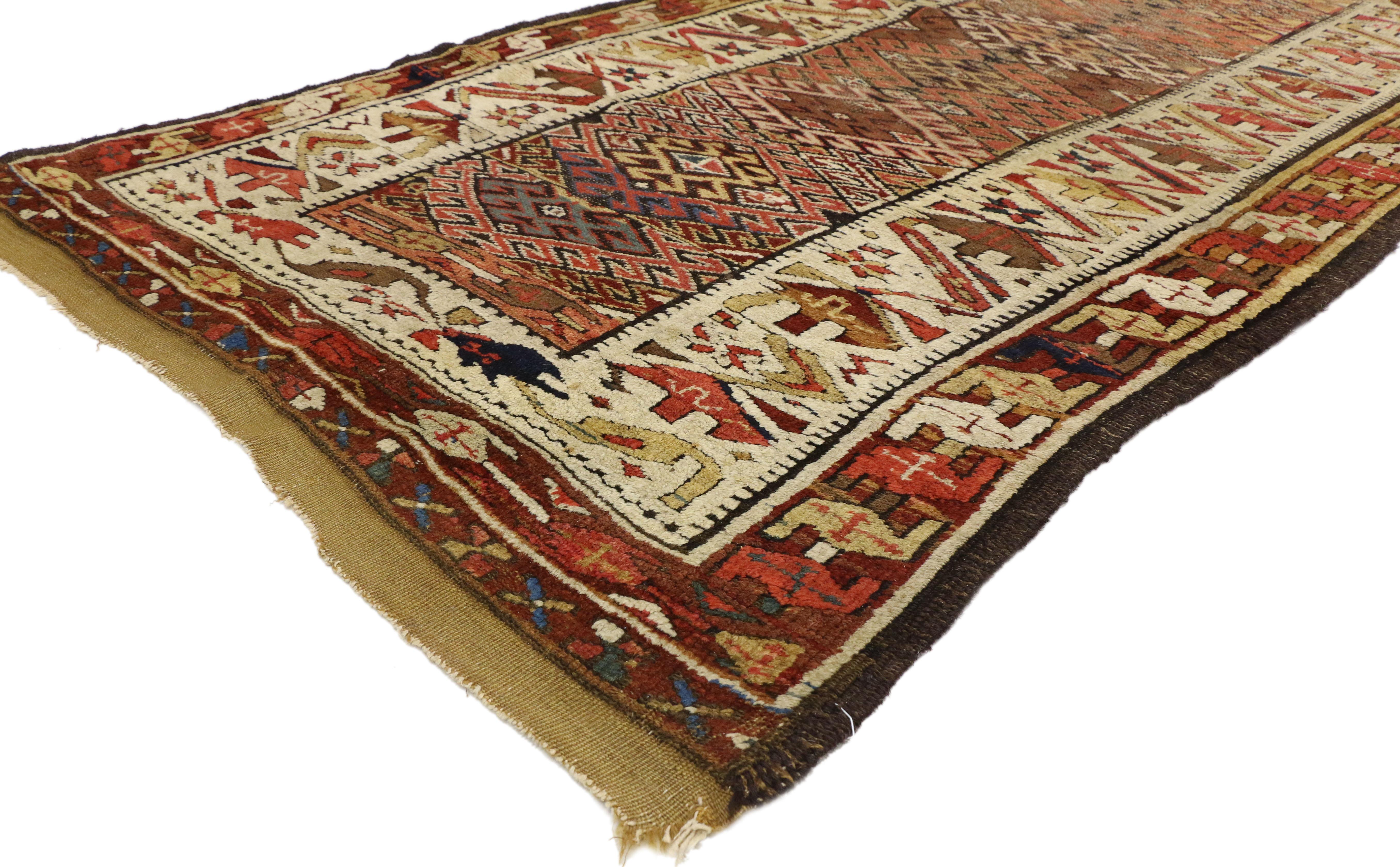 74294, antique Persian Kurdish Tribal runner, hallway runner. Imbued with symbolism, this eclectic antique Persian Kurdish runner with Tribal style exhibits a dynamic personality all its own. Featuring a psychedelic array of colors, interlocking
