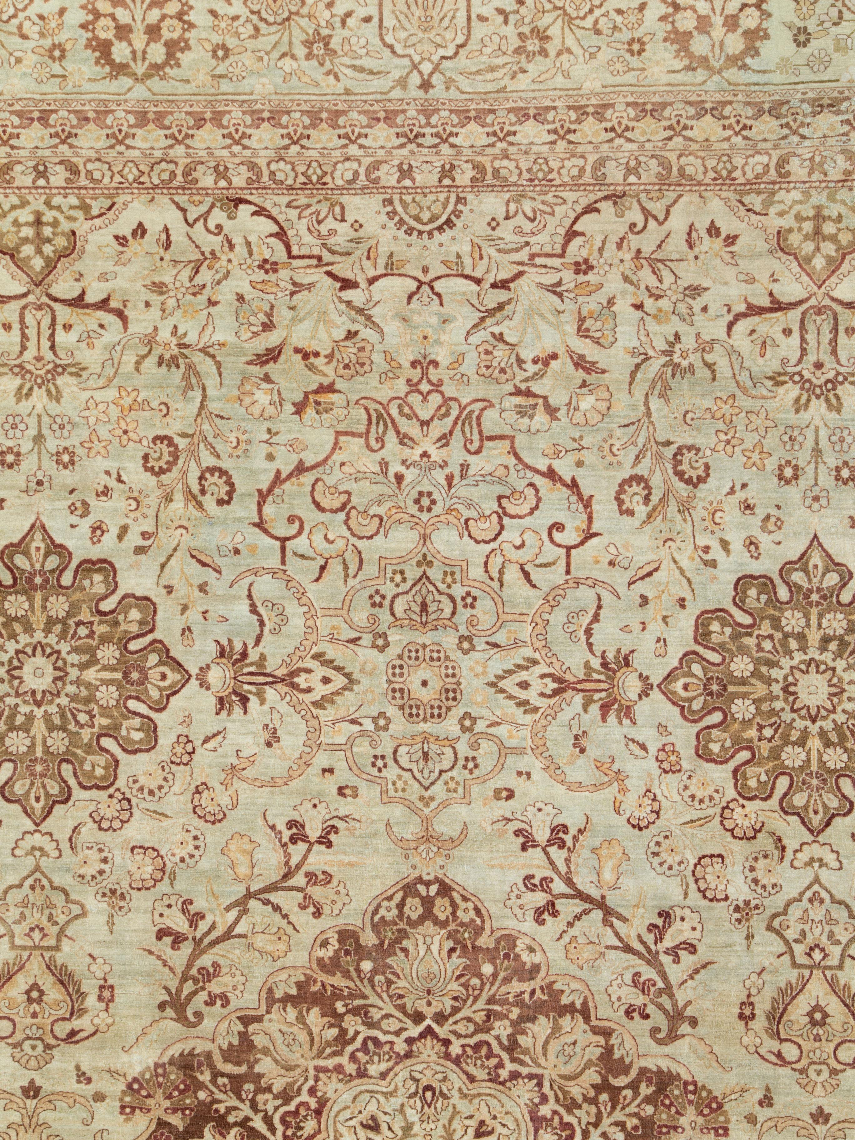 An antique Persian Lavar Kerman carpet from the early 20th century.