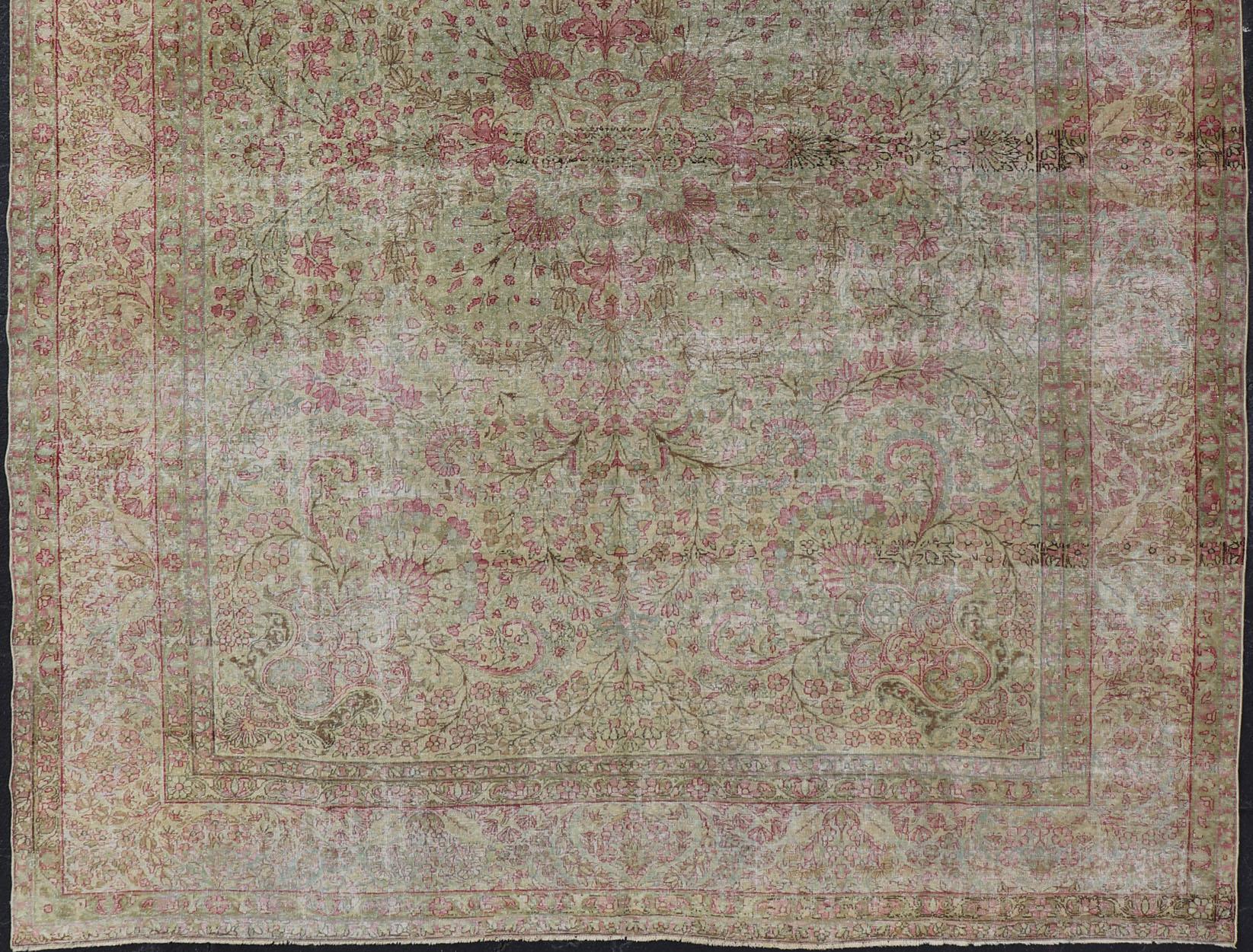 Antique Persian Lavar Kerman distressed rug with multicolored floral motifs, keivan Woven Arts/ rug/D-1210, Country/Iran, 
This beautiful antique distressed Persian Kerman Lavar rug from the early 20th century features very pale yellow green tone