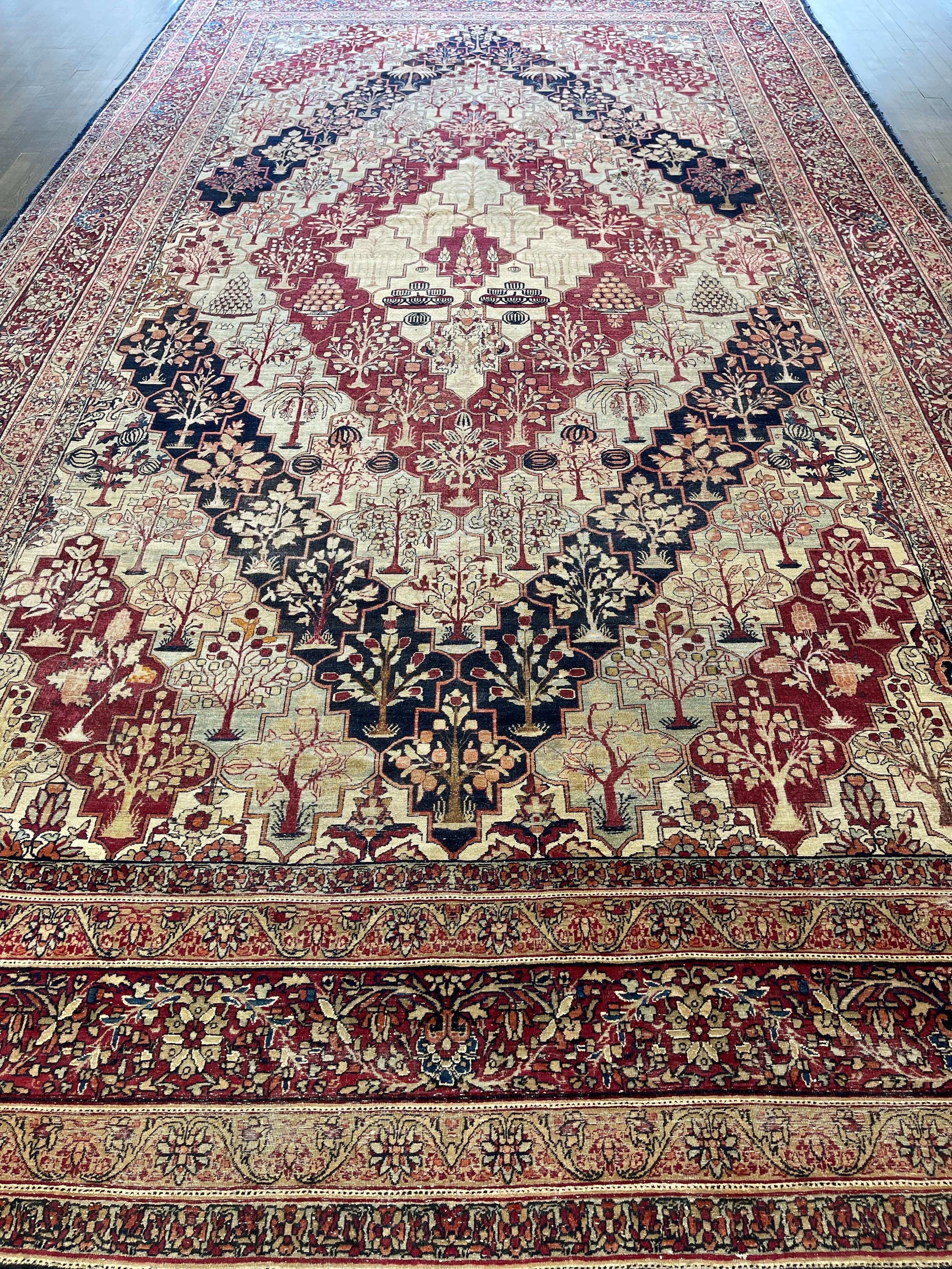 A graceful and color rich wedding carpet,this finely woven rug was created in the town of Lavar near the city of Kerman.Designed with hexagonal shapes,repeated and alternated,finely decorated with over a hundred fruit trees such as pomegranate