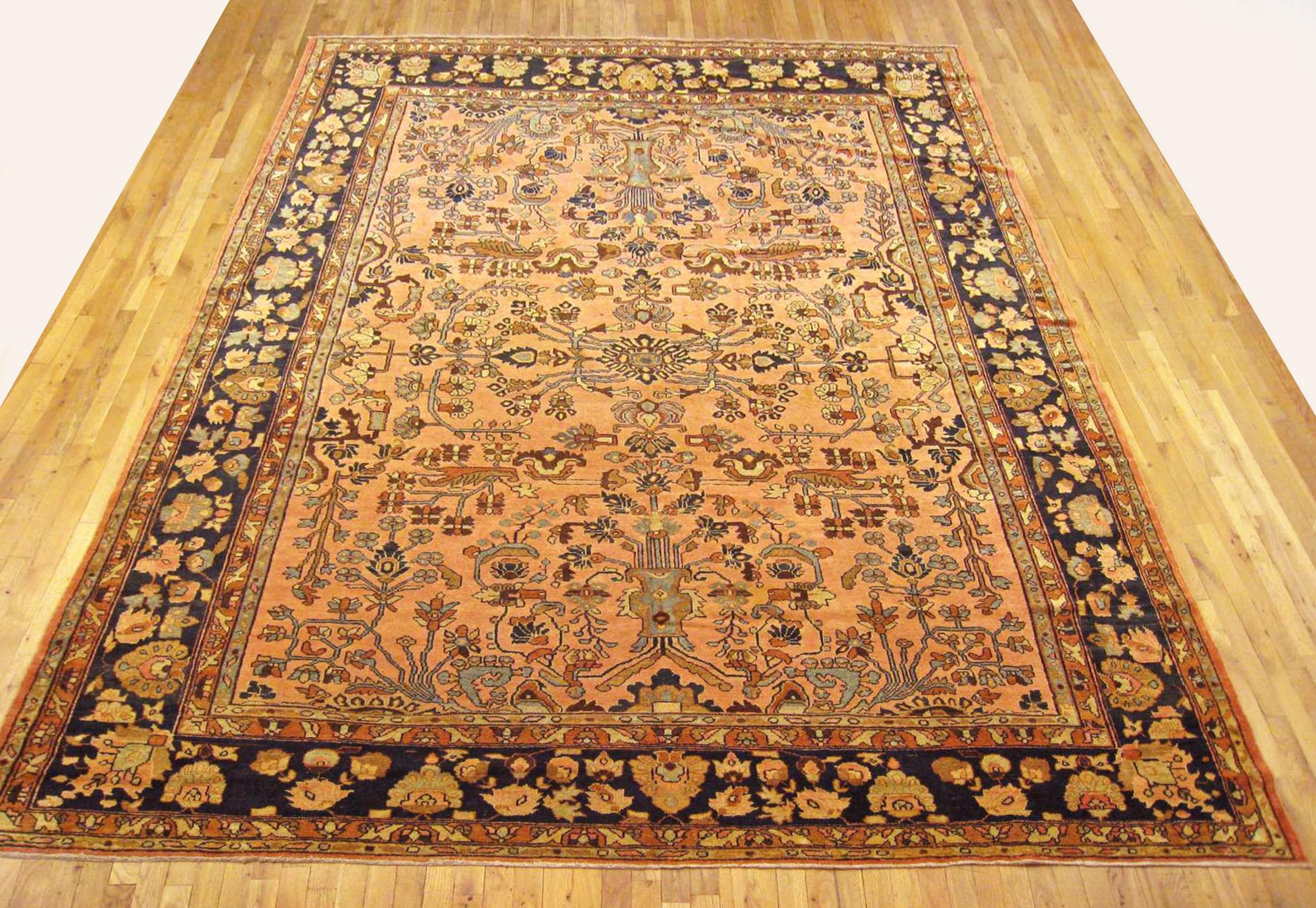 Antique Persian Lilihan rug, room size, circa 1910.

A one-of-a-kind antique Persian Lilihan oriental carpet, hand-knotted with soft wool pile. This lovely hand-knotted carpet features floral elements allover the light shrimp field, with an