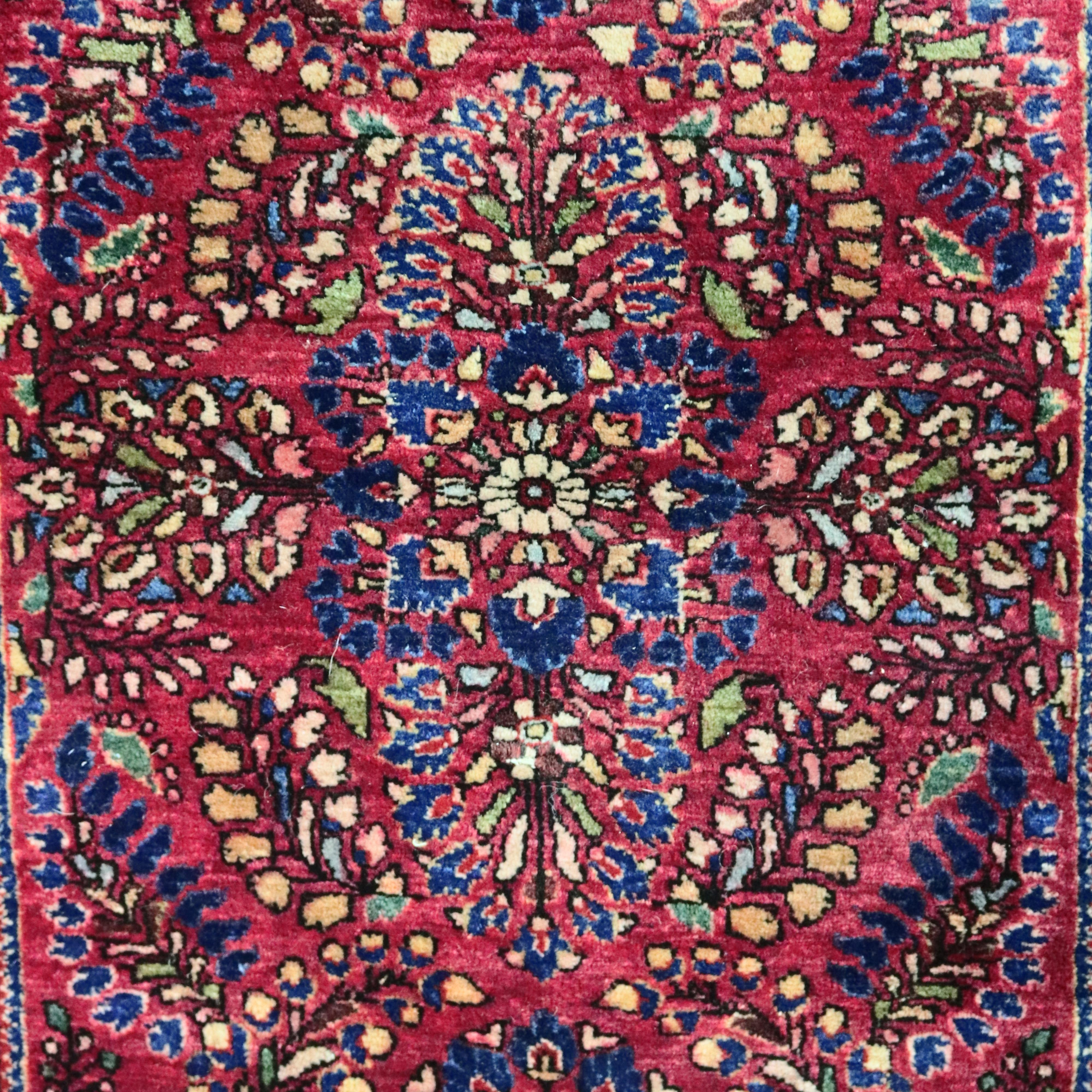 An antique Persian Lillian Sarouk floral oriental rug offers wool construction with floral and tree of life motif on red ground, circa 1921.

Measures: 61