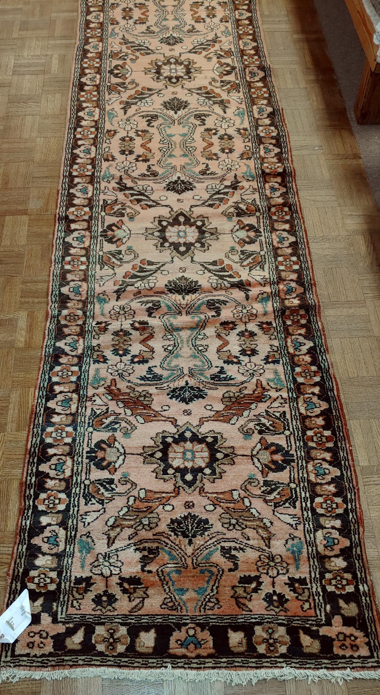 A splendid Persian runner size rug from the village known as a Lilyhan. These rugs were made in a small village near the town of Sarouk. They are known for their less busy motif, distinct pattern, and very soft wool. This piece is form around 1915