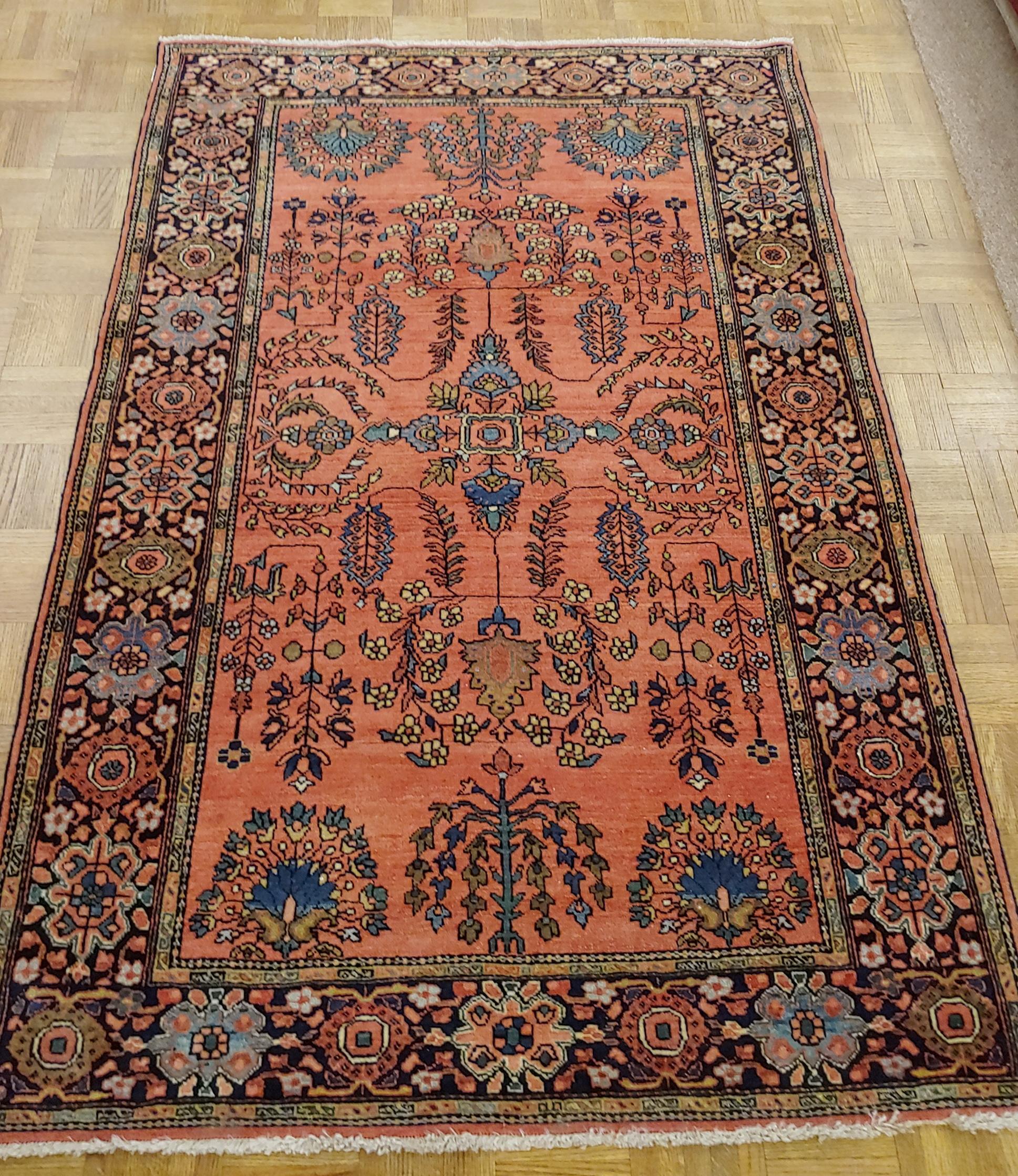 This lovely little Persian Mahajiran Sarouk is fabulous. It is circa 1910 in almost perfect condition. The rust field is decorated with light blue and green flowers. The wool feels like silk. It is a scatter size: 3-4 x 5-1.