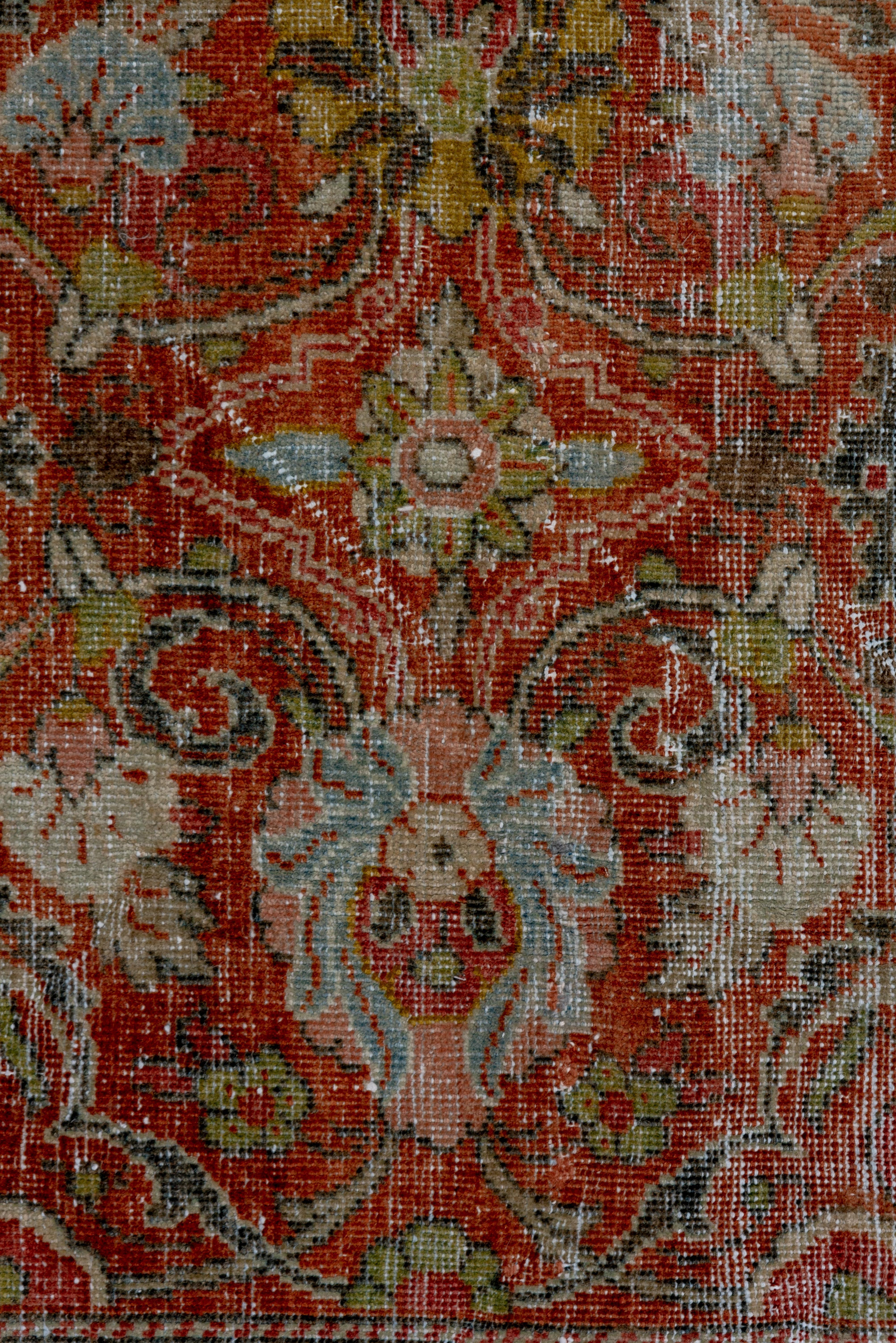 The Mahal rug is very attractive with some mild and even wear. It has a rust field that displays dynamic green arabesques, various palmettes and triple straw rosettes. The green border shows petal palmettes and recurved leaves. Shabby chic and