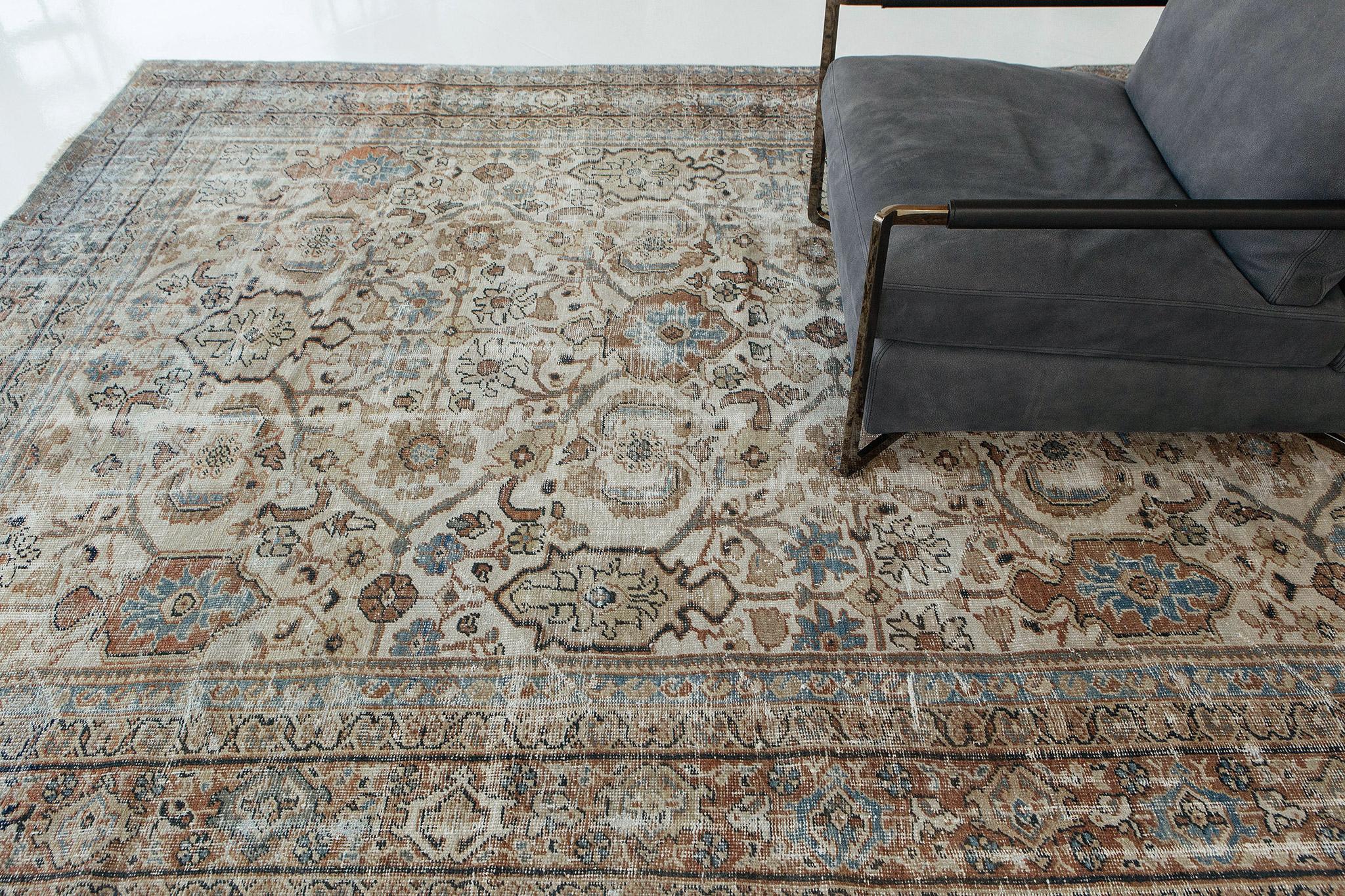 This rugs time-softened color palette combined with a highly industrial aesthetic highlight a medley of intricately composed geometric motifs creating a rhythmic, majestic cadence throughout its weathered composition. The borders are harmoniously