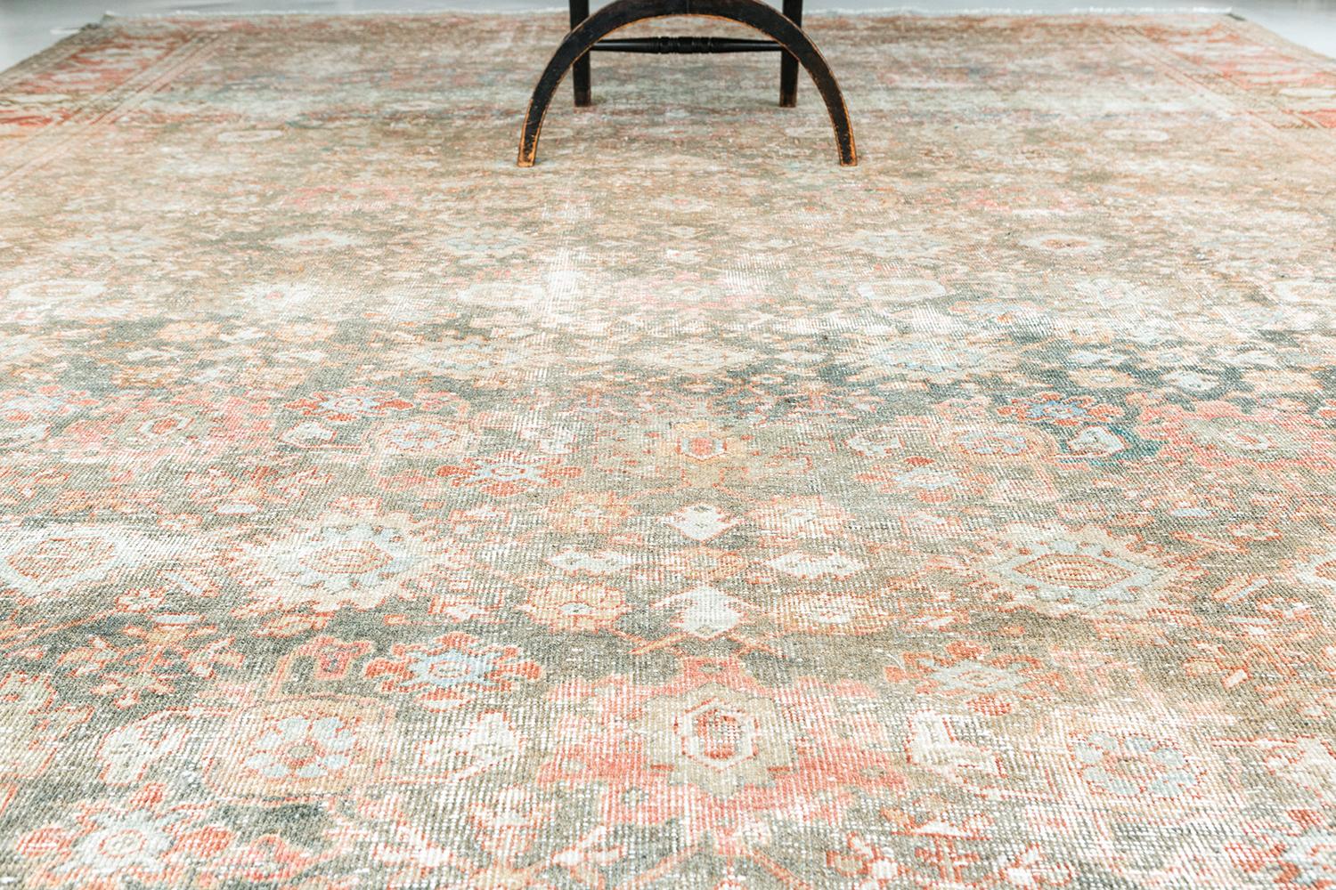 A luxurious antique Persian Mahal with beautiful saturated wools and a timely design for both modern and more traditional settings. Antique blues and reds make for a perfect color combination amongst the distressed texture that leaves a tasteful