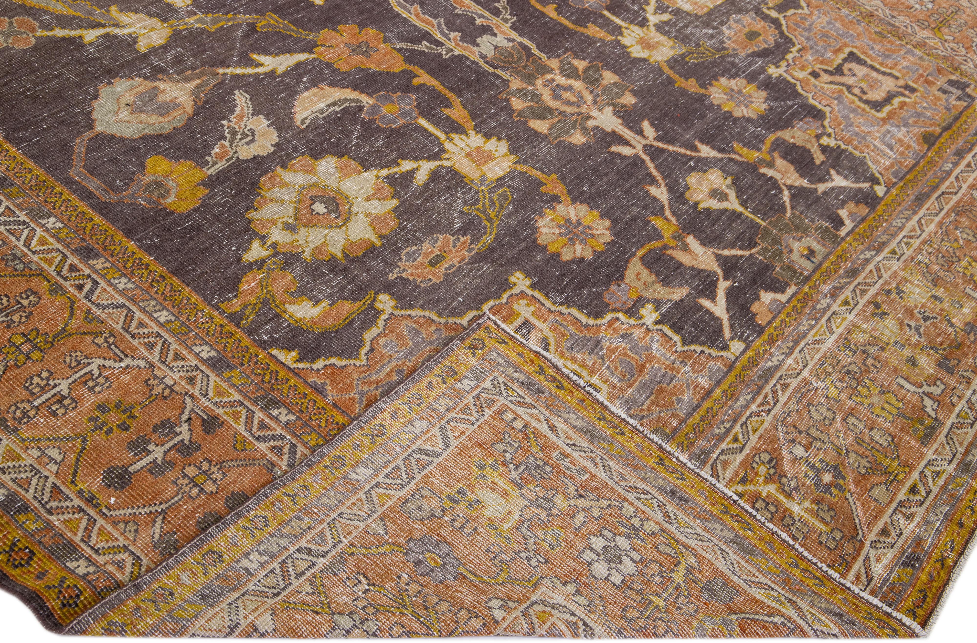 A beautiful Antique Mahal hand-knotted wool rug with a gray field. This Persian rug has rust-orange color accents in an all-over floral medallion design.

This rug measures 9'10